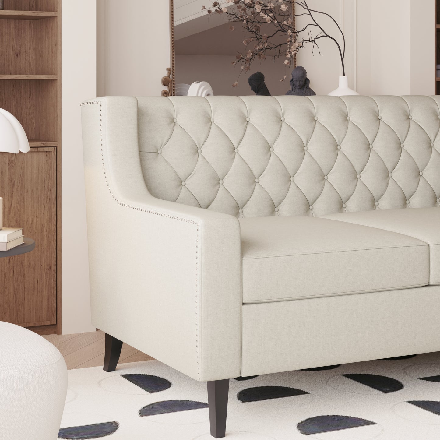 Tufted cream fabric sofa with silver nailhead trim perfect for a living room centerpiece