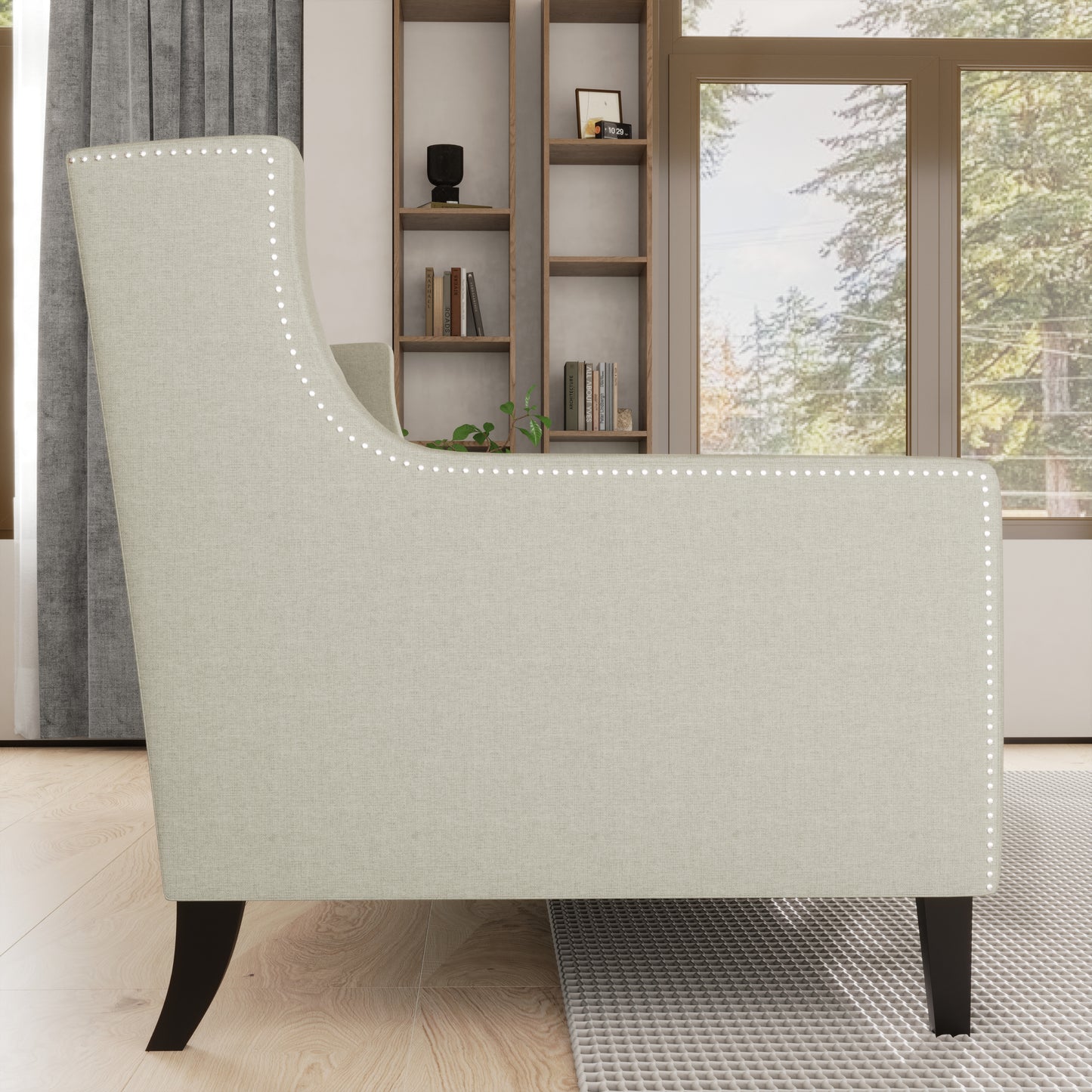 Light beige upholstered armchair with silver nailhead trim and dark wooden legs