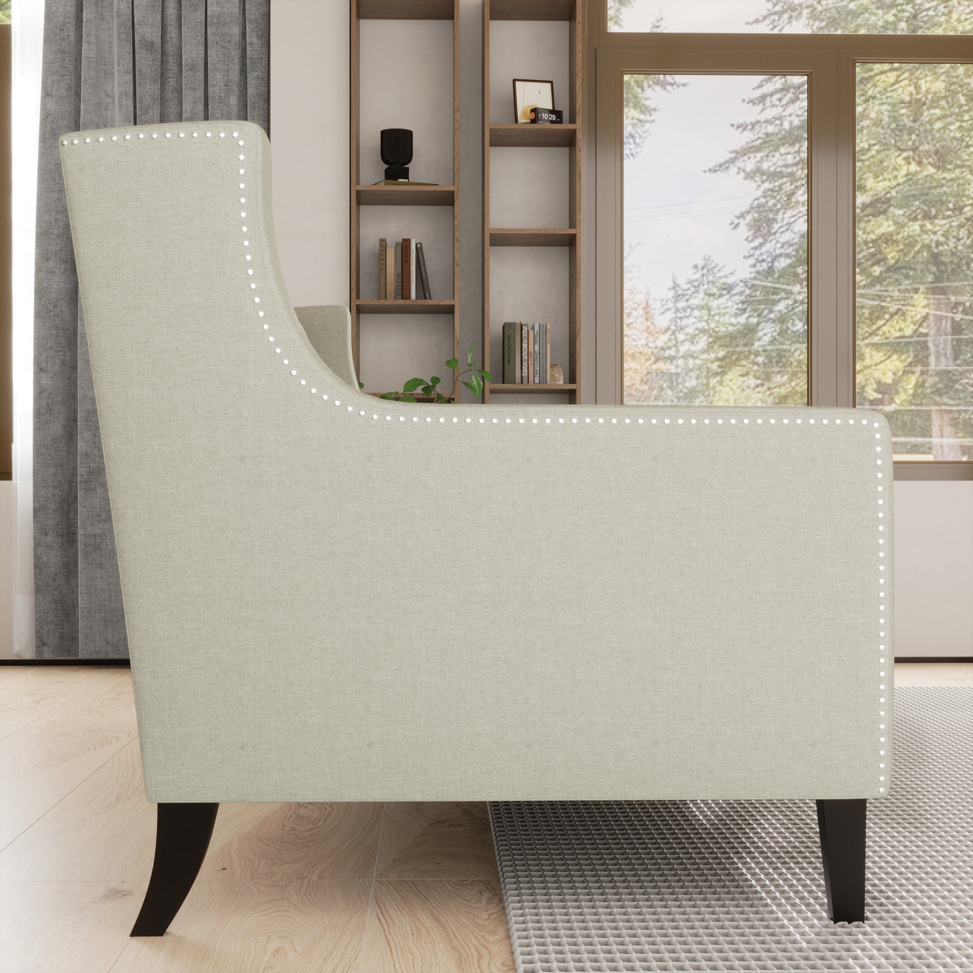 Light beige upholstered armchair with silver nailhead trim and dark wooden legs