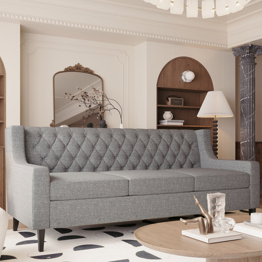Grey fabric tufted sofa with nailhead trim perfect for living room