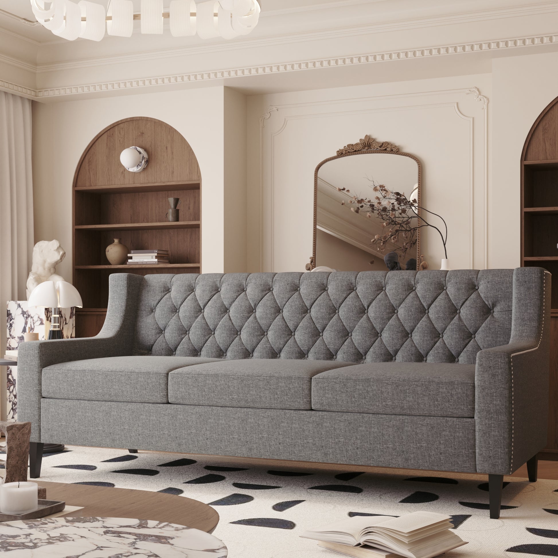 Grey tufted sofa with nailhead trim offering a classic design for living rooms