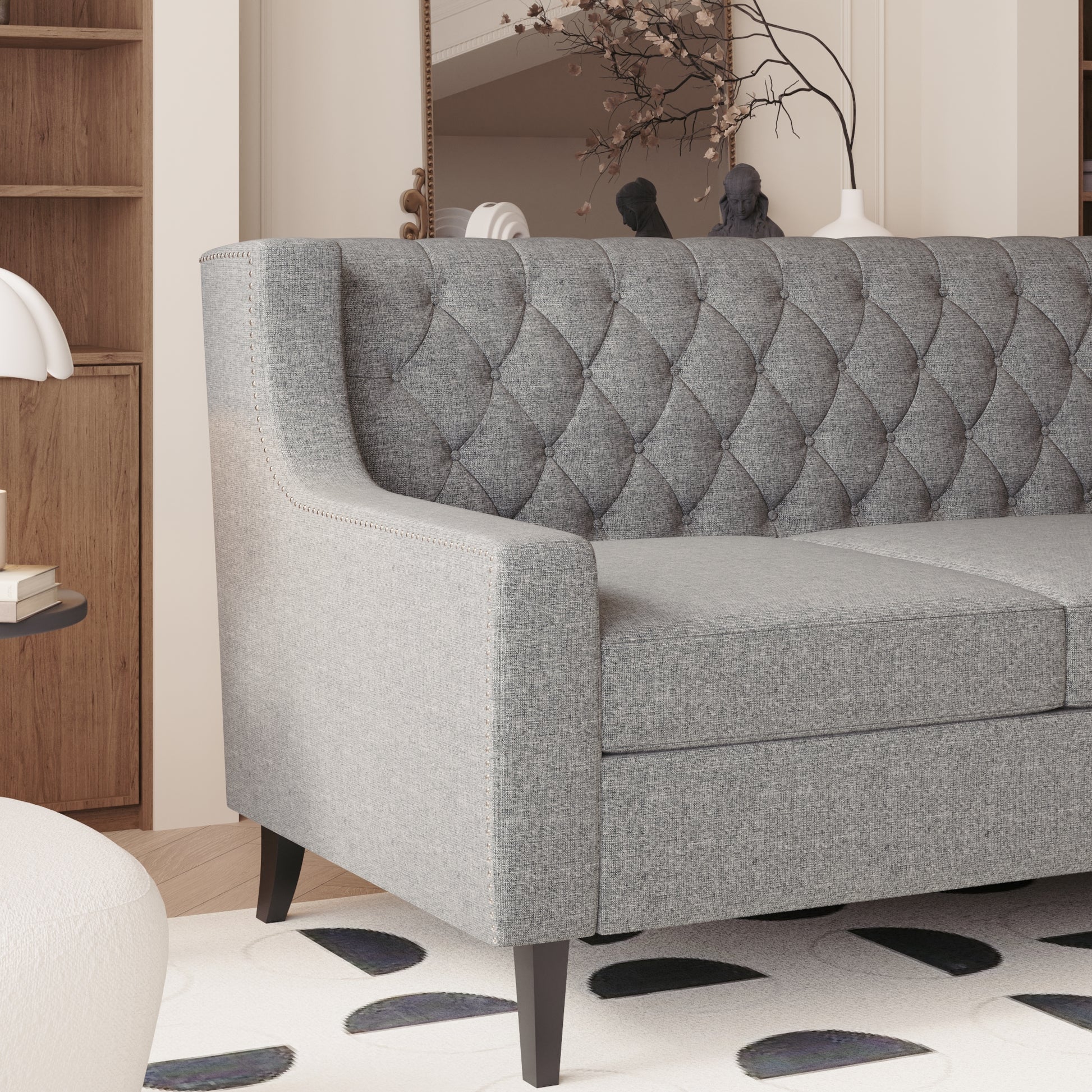 Tufted grey linen sofa with silver nailhead trim a modern living room centerpiece