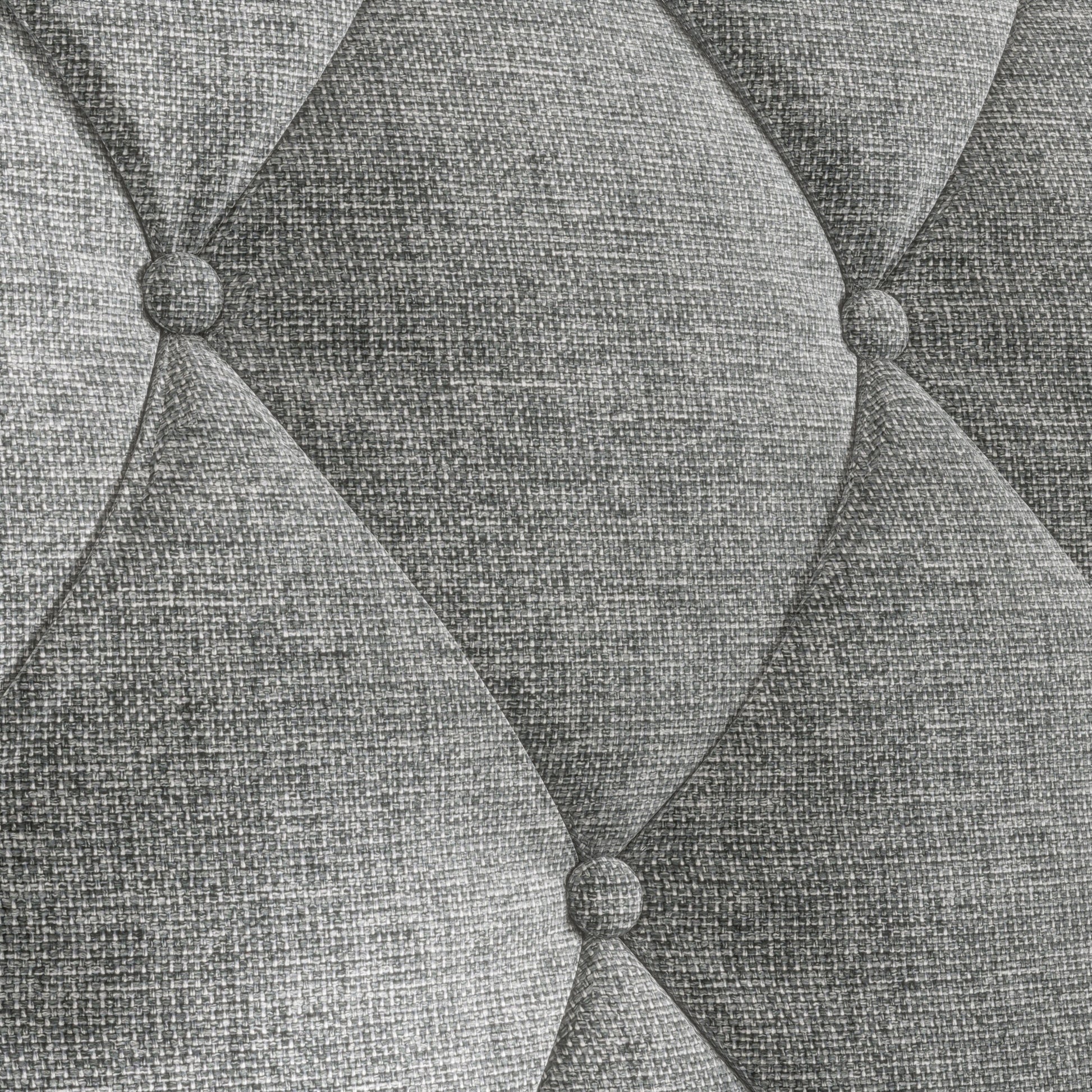 Closeup of grey tufted fabric texture with diamond pattern ideal for upholstery