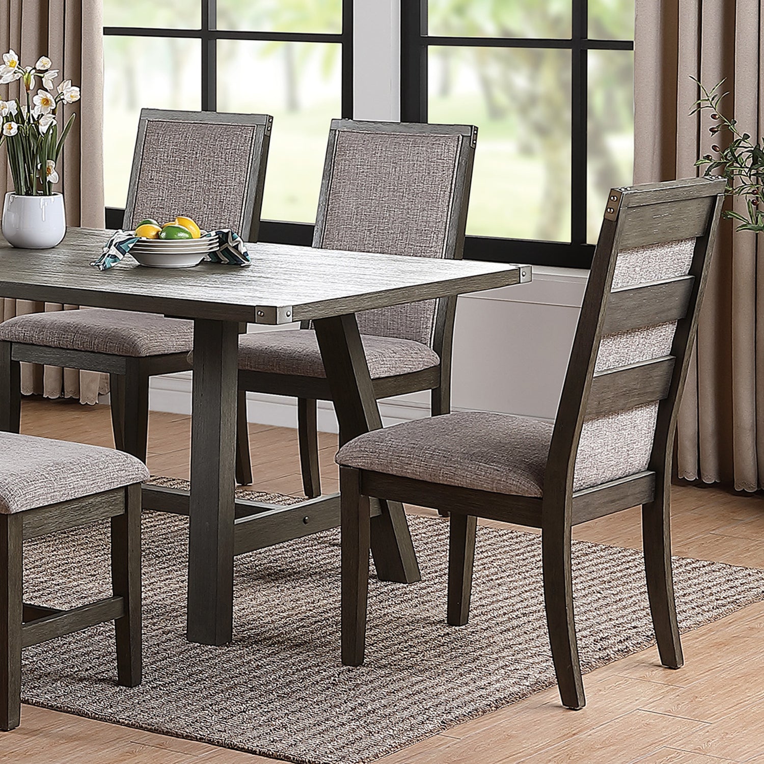Dark gray wooden dining chairs with textured gray upholstered seats and backs