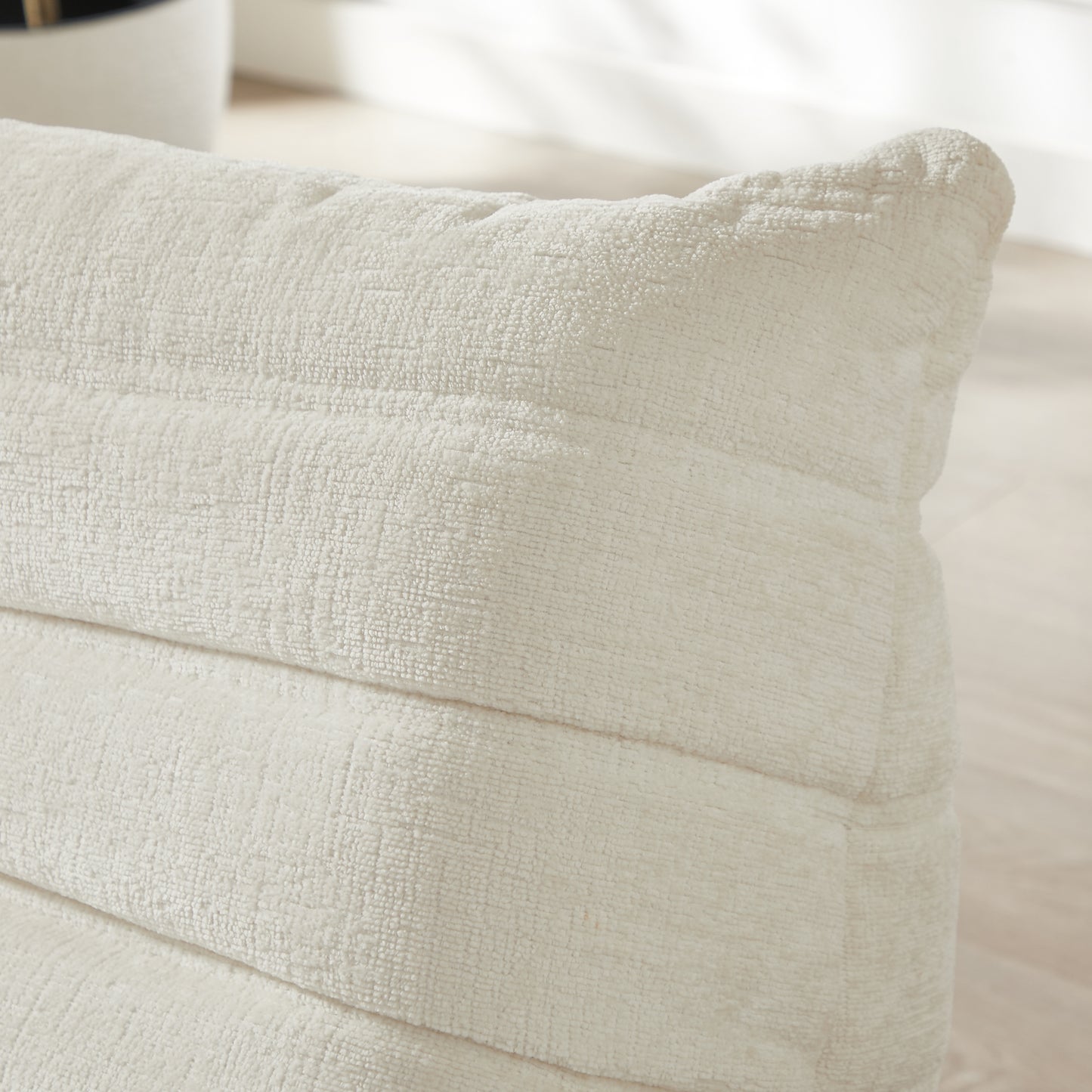 Cream textured throw pillow with subtle horizontal ribbing detail