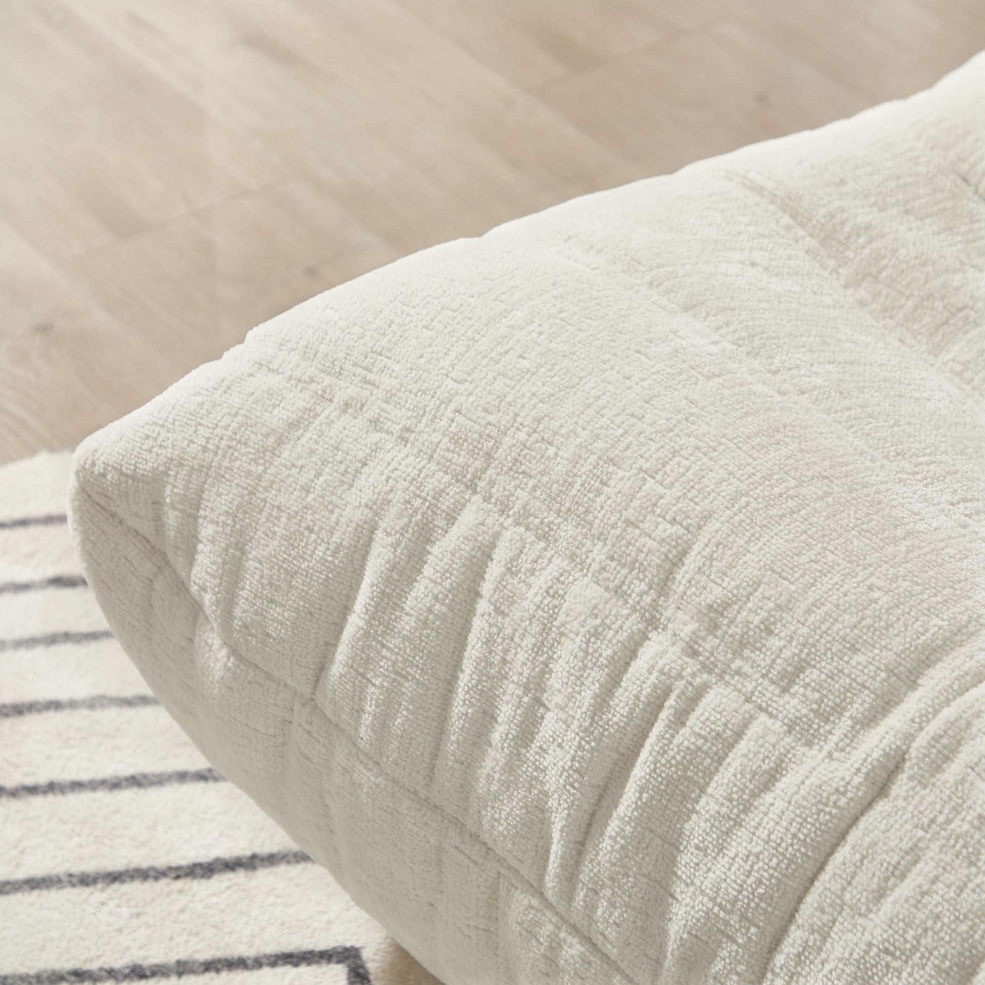 Cream textured floor cushion with stitched detail