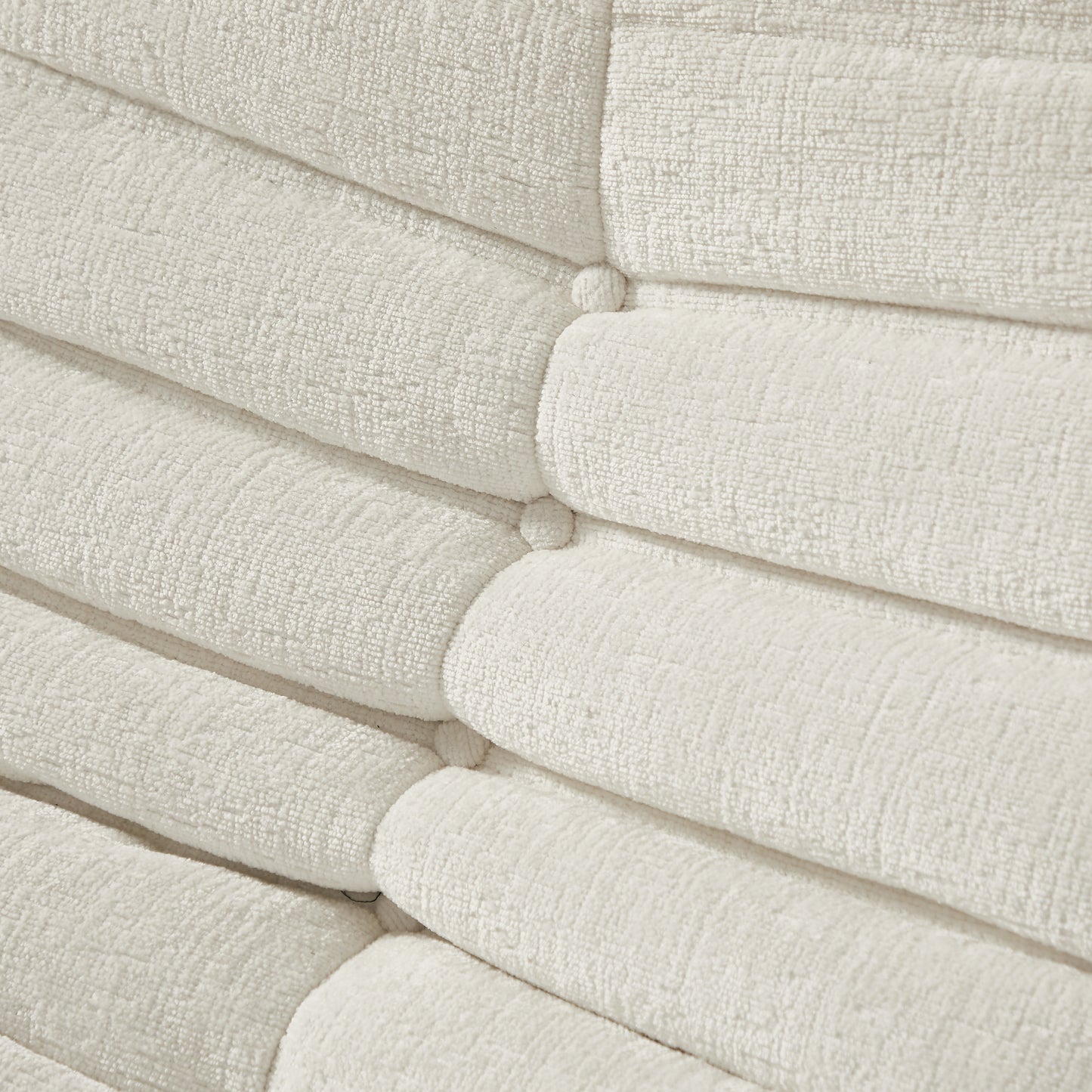 Textured ivory chenille fabric with deep channel tufting and button accents