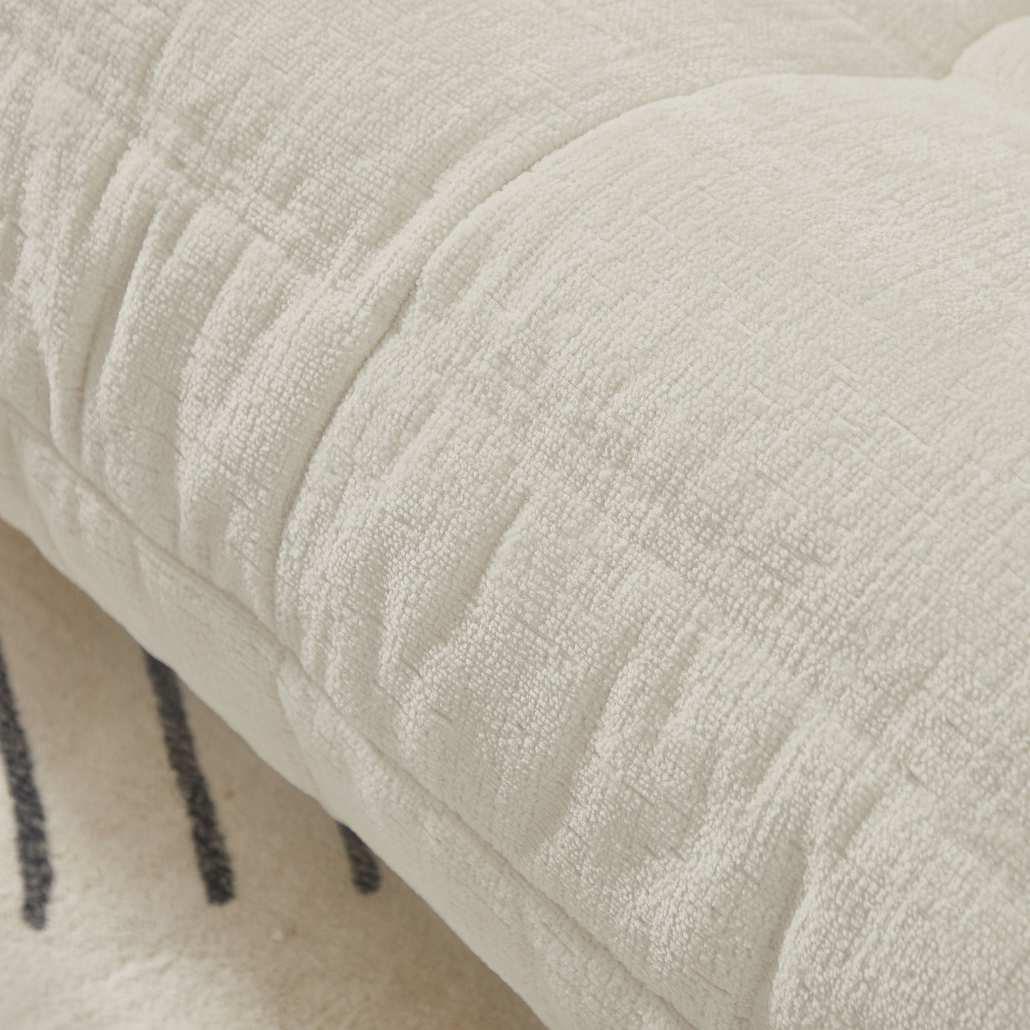 Closeup of plush cream chenille throw pillow with textured fabric for cozy home decor