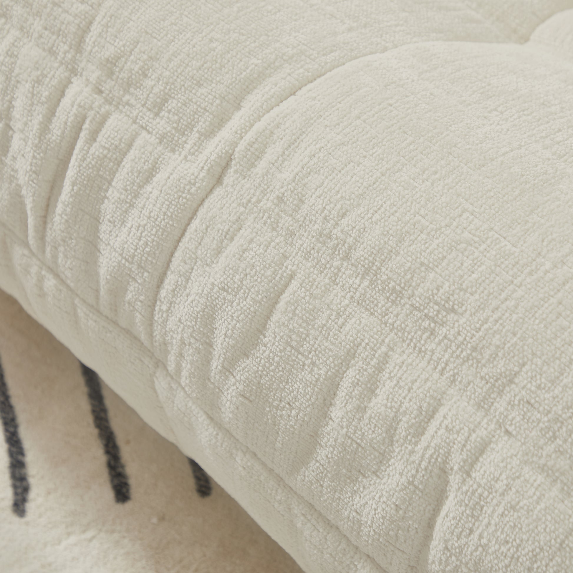 Closeup of plush cream chenille throw pillow with textured fabric for cozy home decor