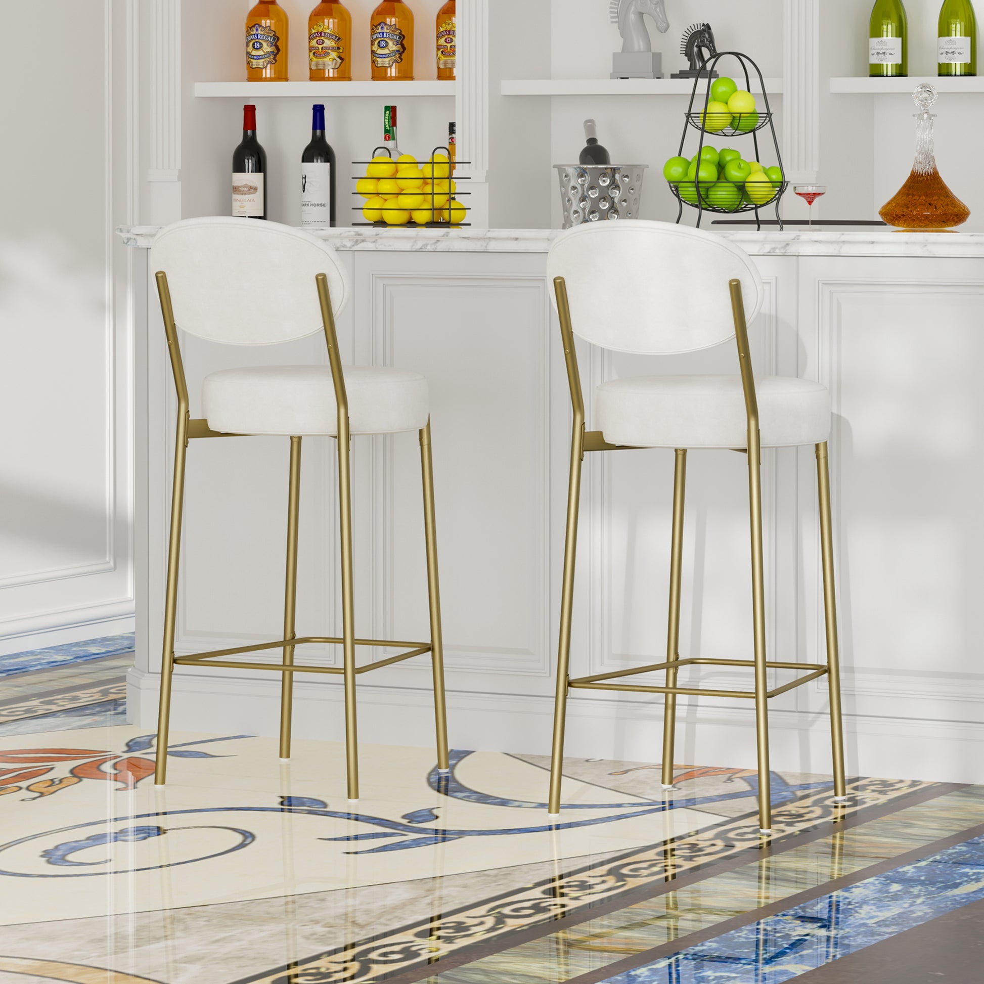 Two white upholstered bar stools with gold metal legs in a modern home bar setting