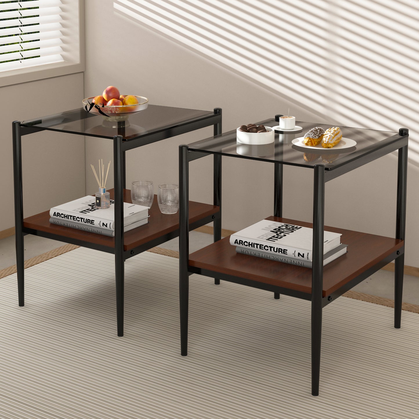 Black metal and glass end table with two shelves holding books and decor