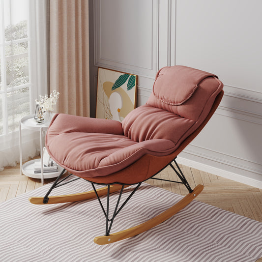 Plush rosepink upholstered accent chair with a black metal frame and wood rocking base