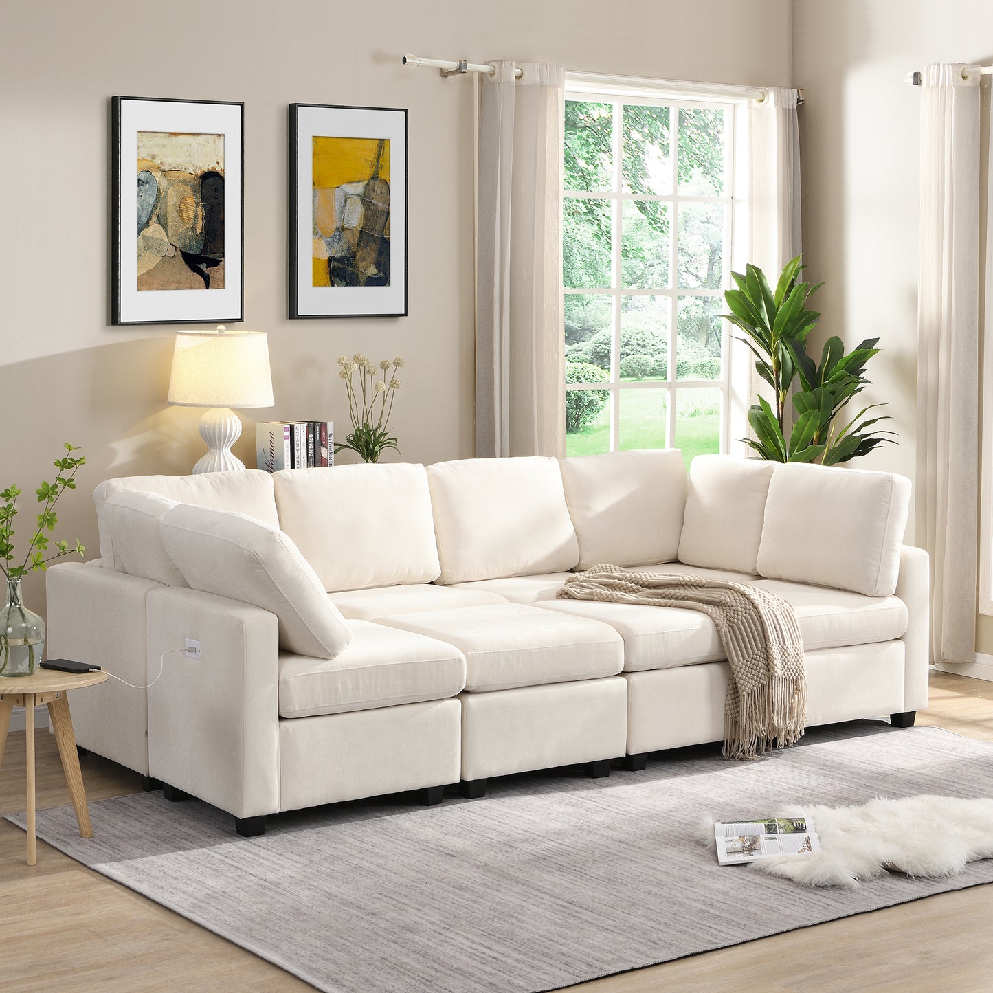 Cream modular sectional sofa with plush cushions and a woven throw blanket