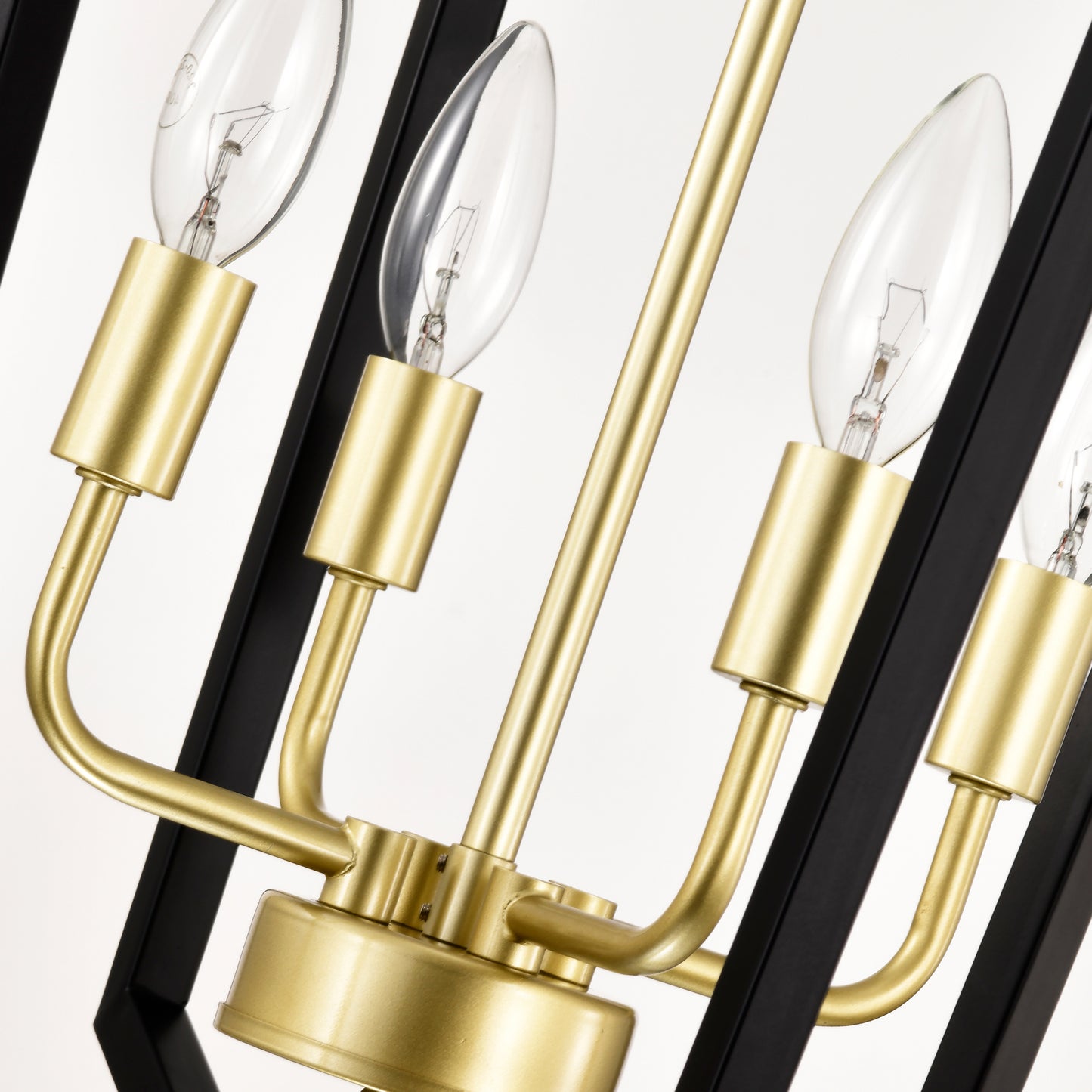 Closeup of a brass and black modern chandelier with clear candelabra bulbs