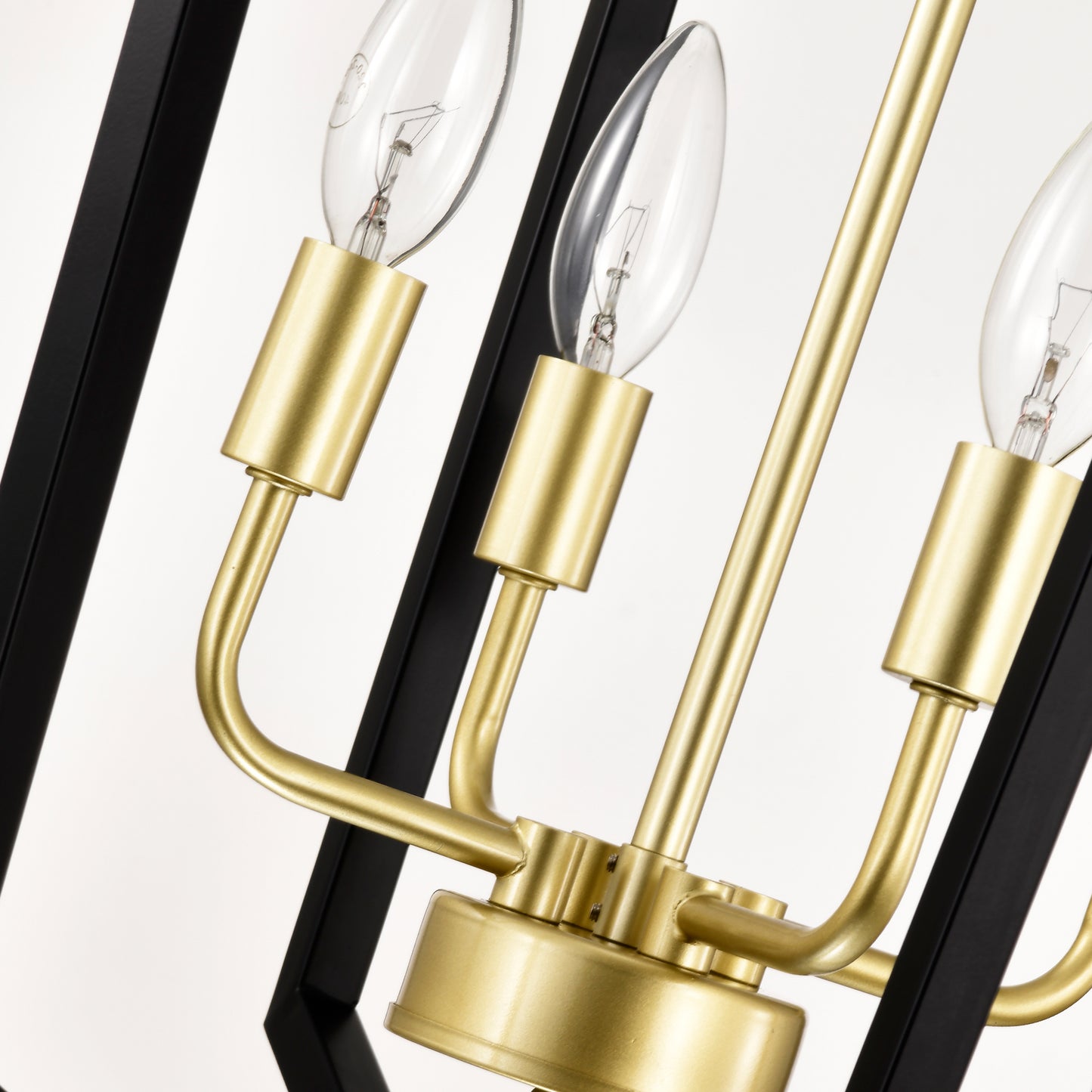 Closeup of black and brass chandelier with clear Edison bulbs