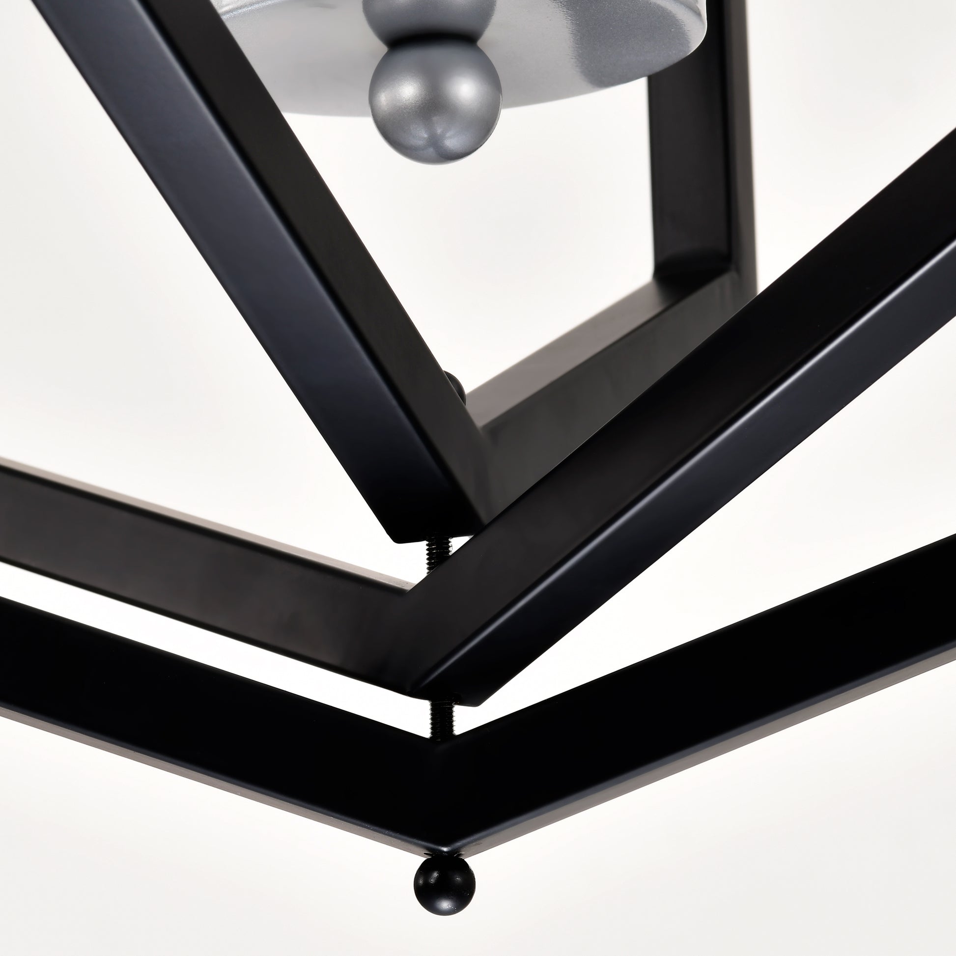 Modern black metal geometric pendant light fixture with silver bulb detail