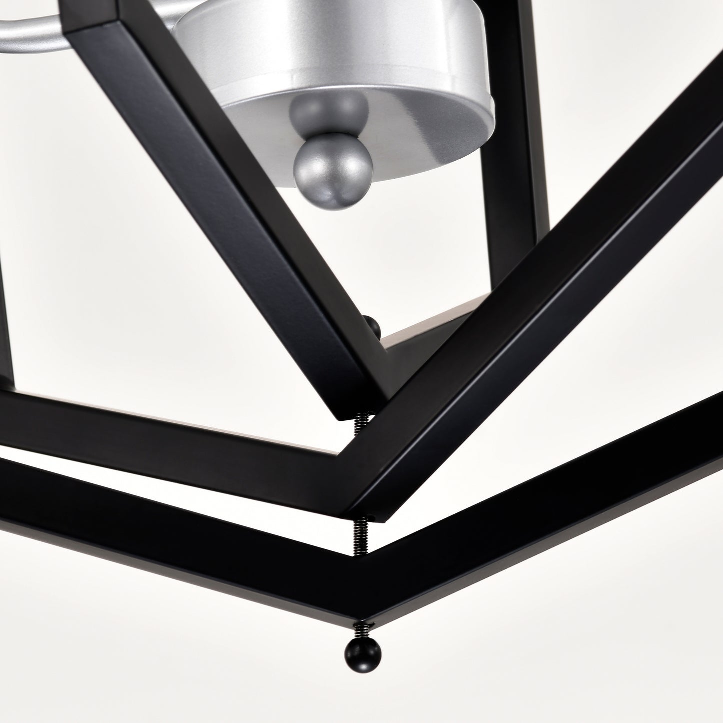Closeup of modern black geometric chandelier frame with brushed silver accents