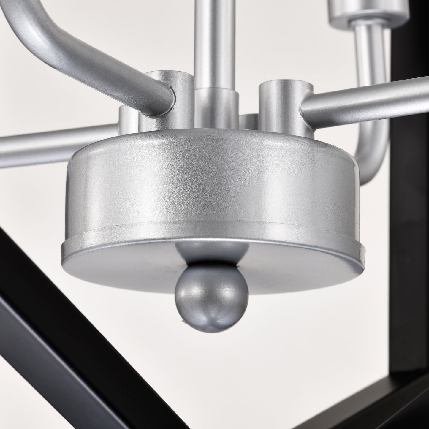 Closeup of a silver metal ceiling light fixture with matte finish and black accents