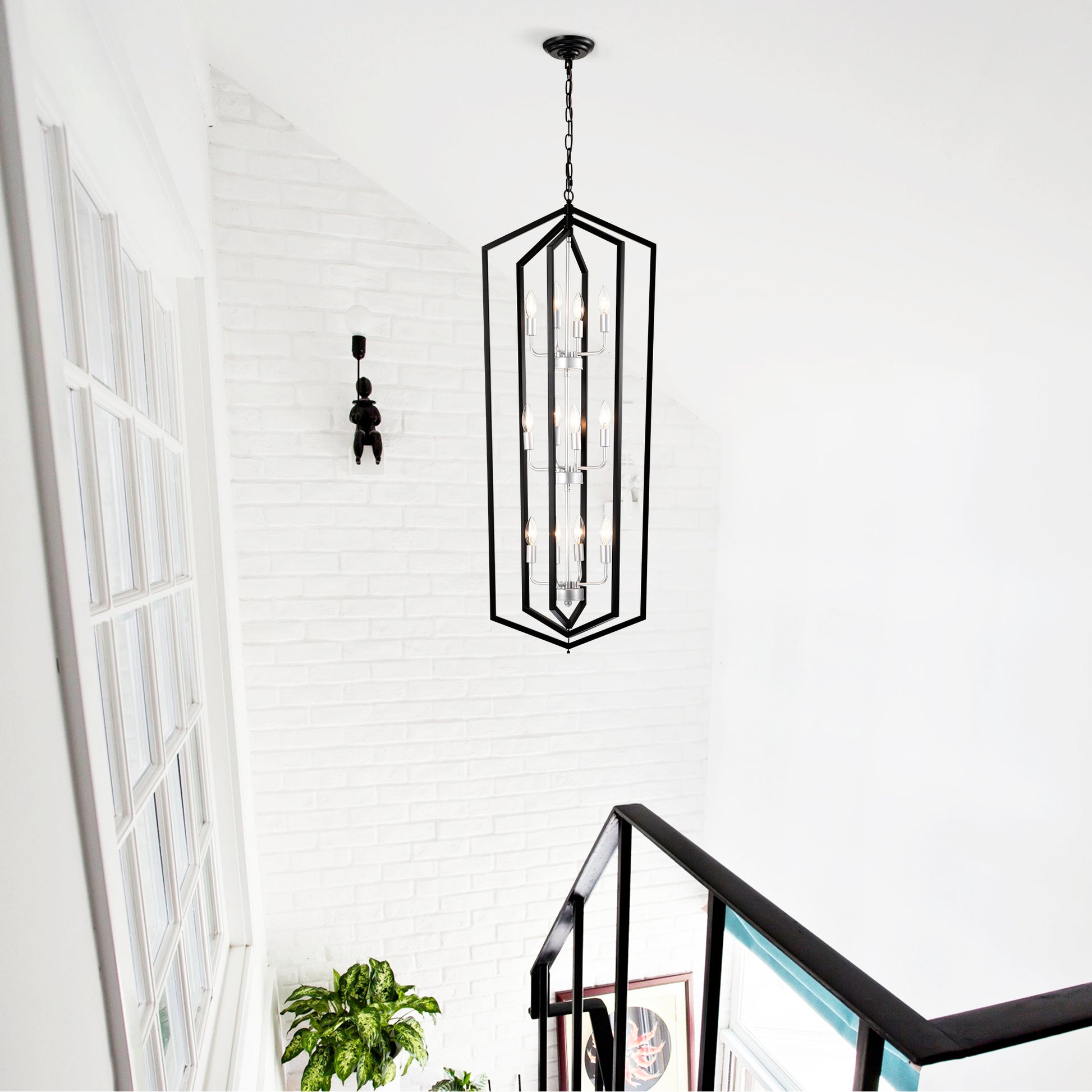 Modern black geometric lantern chandelier with  lights illuminating a stairwell