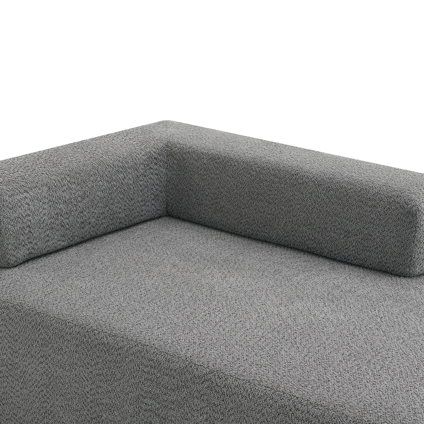 Corner detail of a textured grey fabric modular sofa with a plush finish