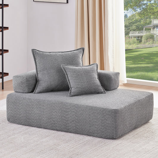 Plush grey boucl fabric chaise lounge with accent pillows perfect for modern living rooms