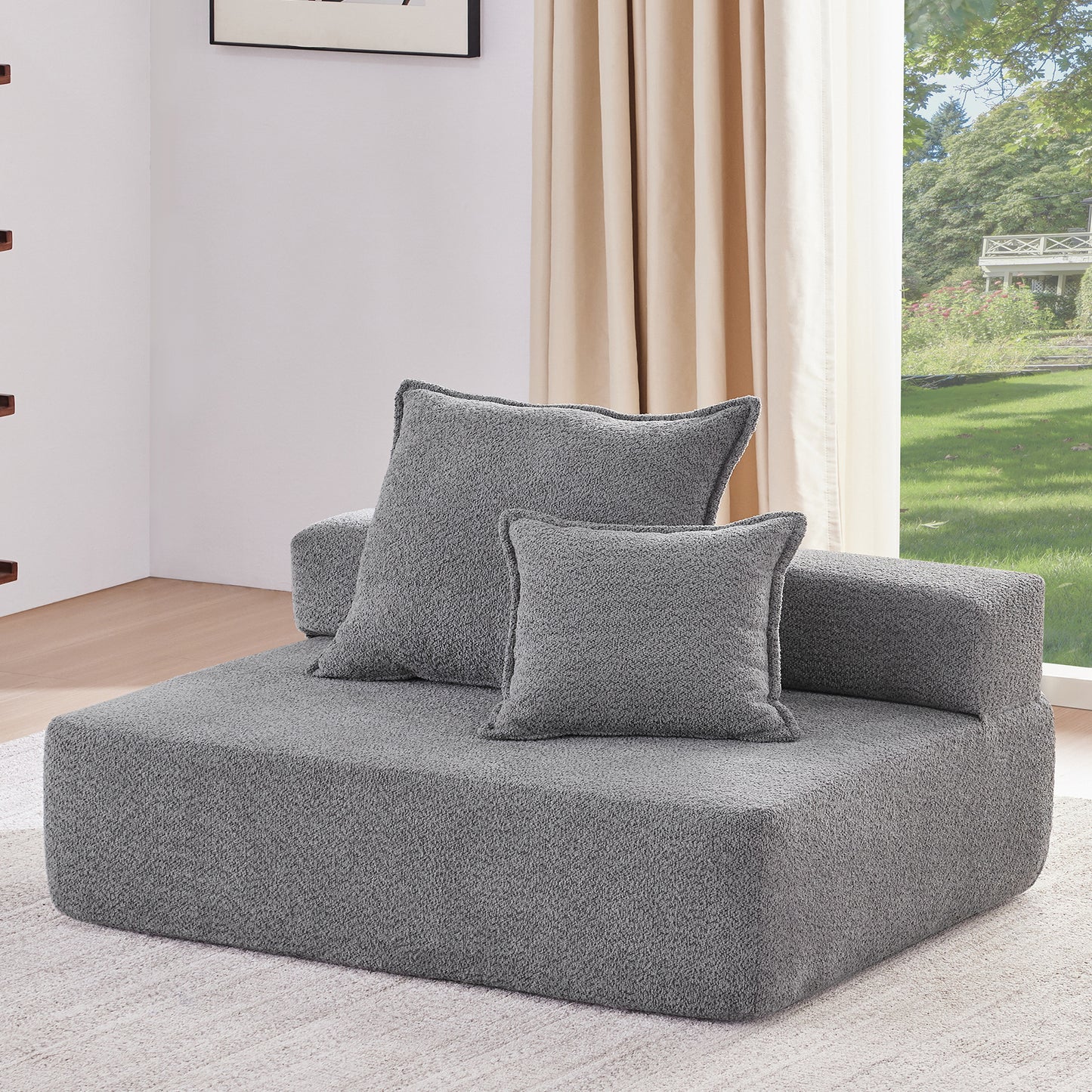 Plush gray modular sofa with two textured throw pillows perfect for a cozy living room setup