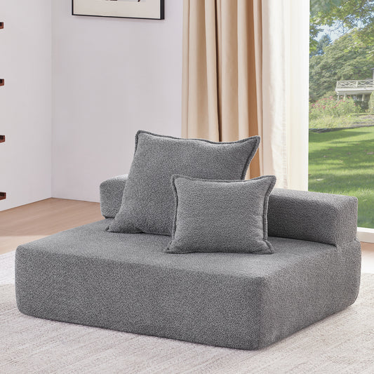 Plush gray modular sofa with two textured throw pillows perfect for a cozy living room setup