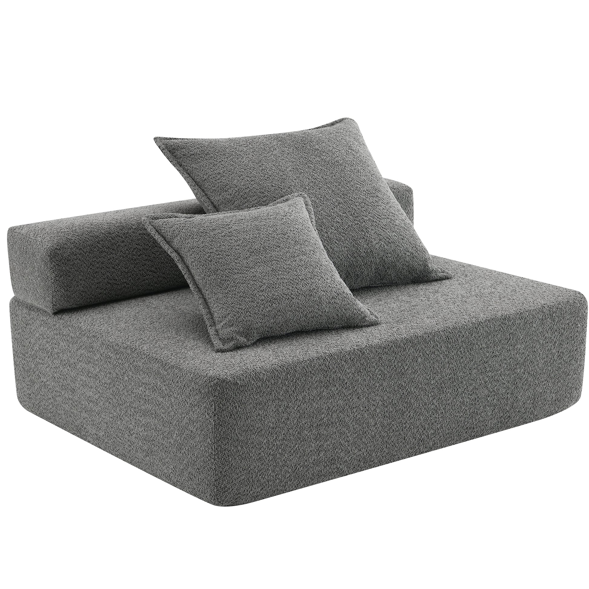 Modern grey modular sofa with textured fabric and two throw pillows