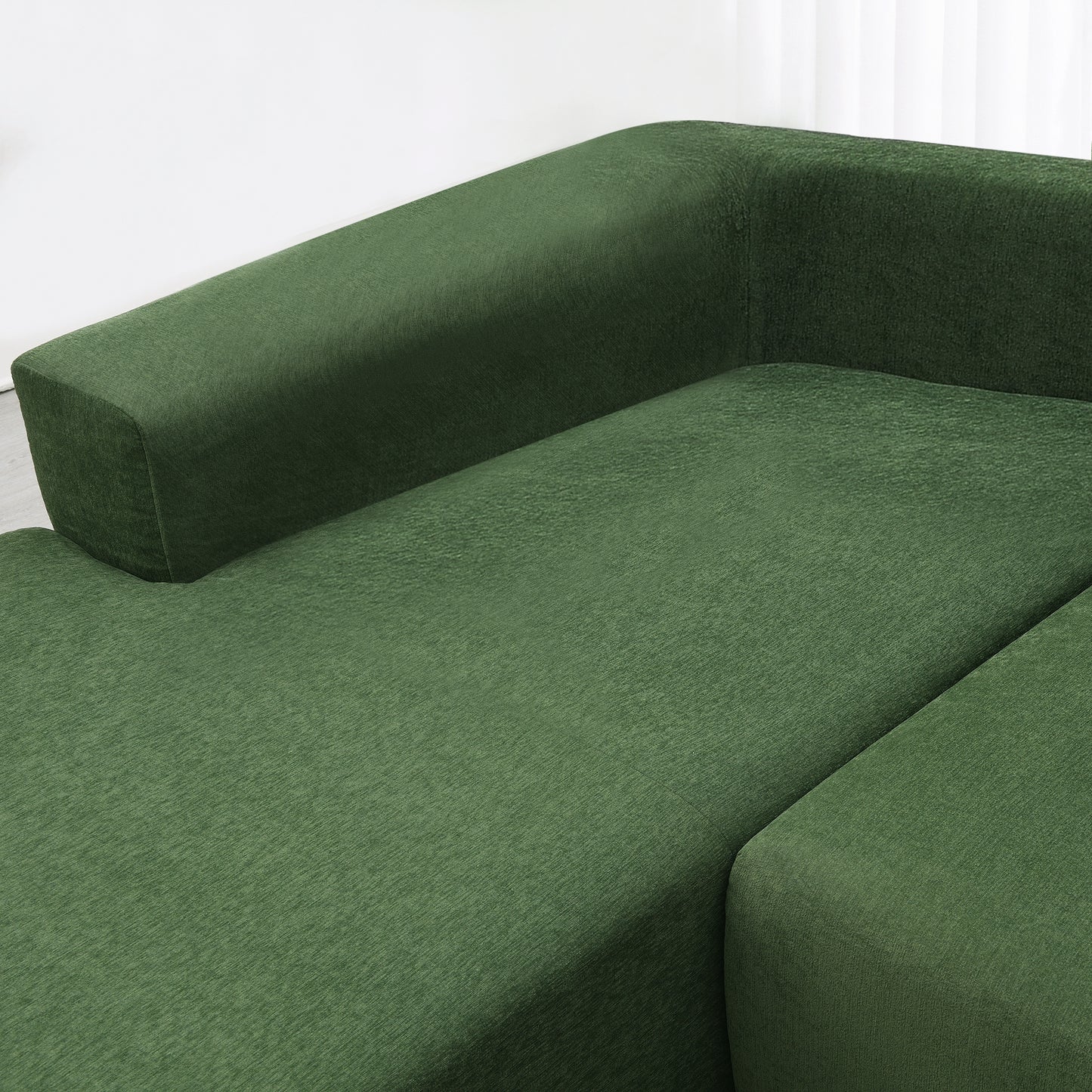 Deep forest green sectional sofa with plush textured fabric upholstery