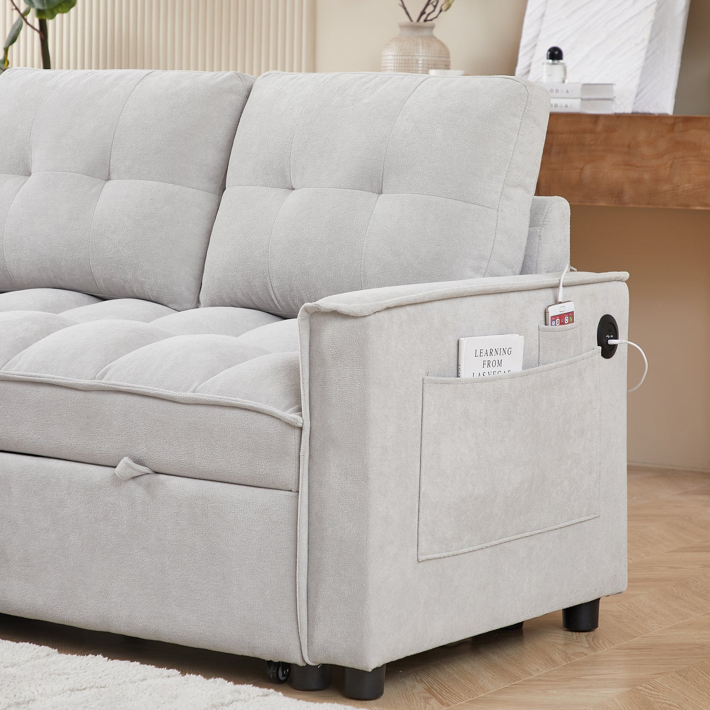 Light grey fabric sofa with tufted cushions and a builtin side pocket