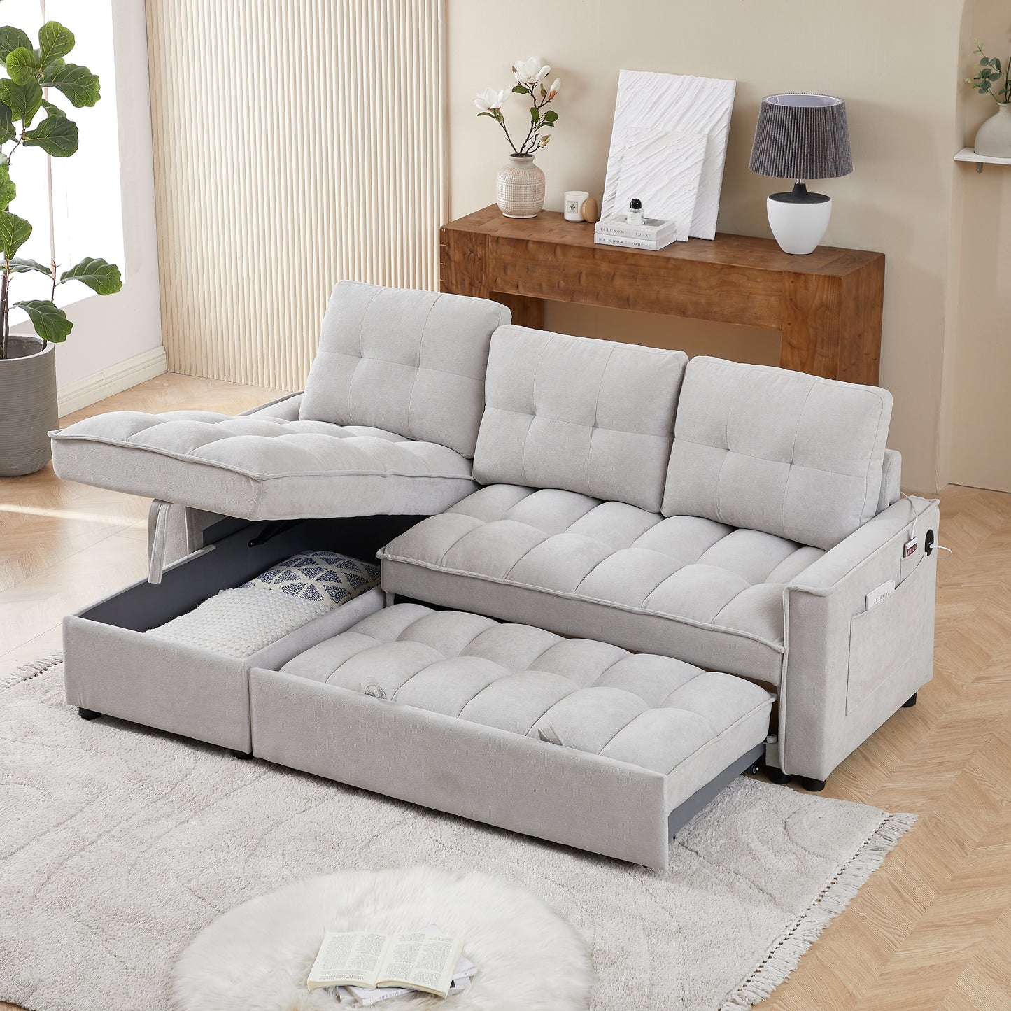 Light grey fabric sleeper sofa with pullout bed and hidden storage compartments