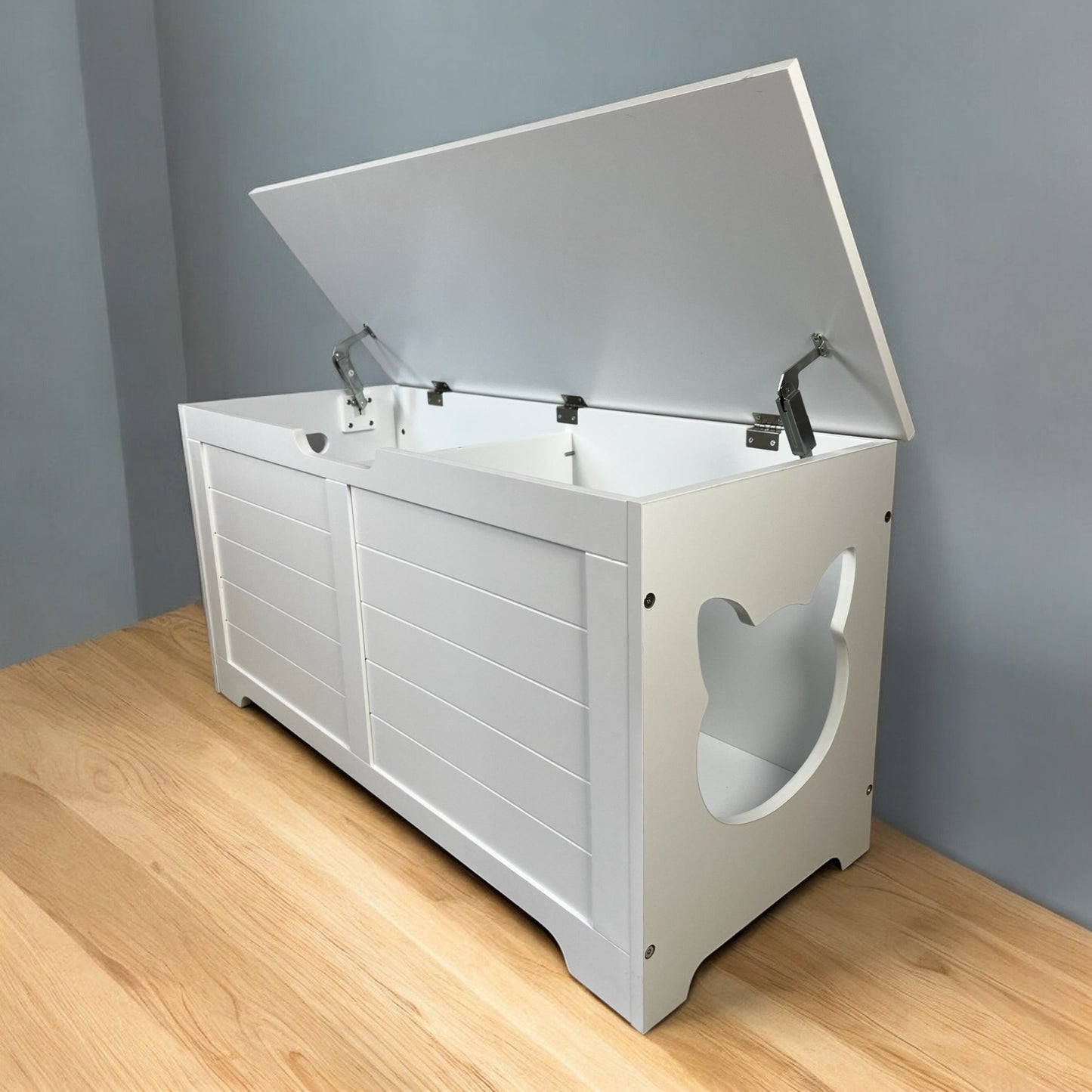 White wooden toy chest with a hinged lid and catshaped cutouts