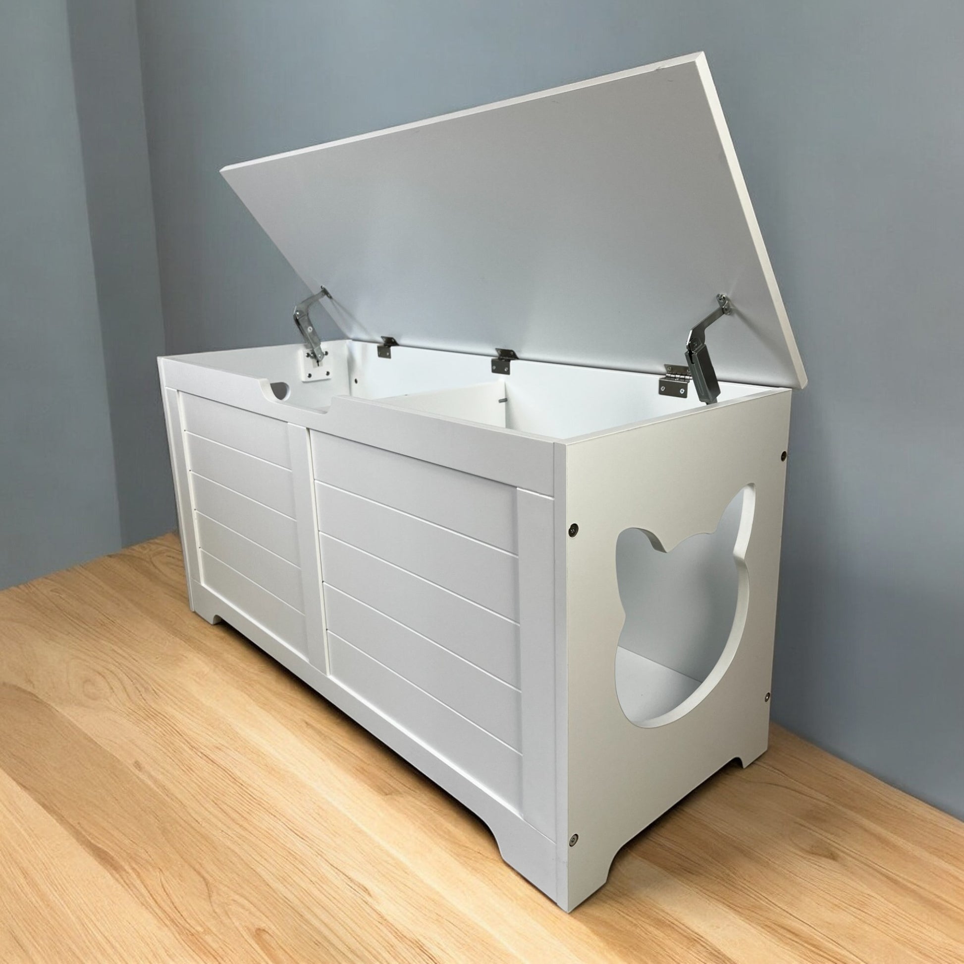 White wooden toy chest with a hinged lid and catshaped cutouts