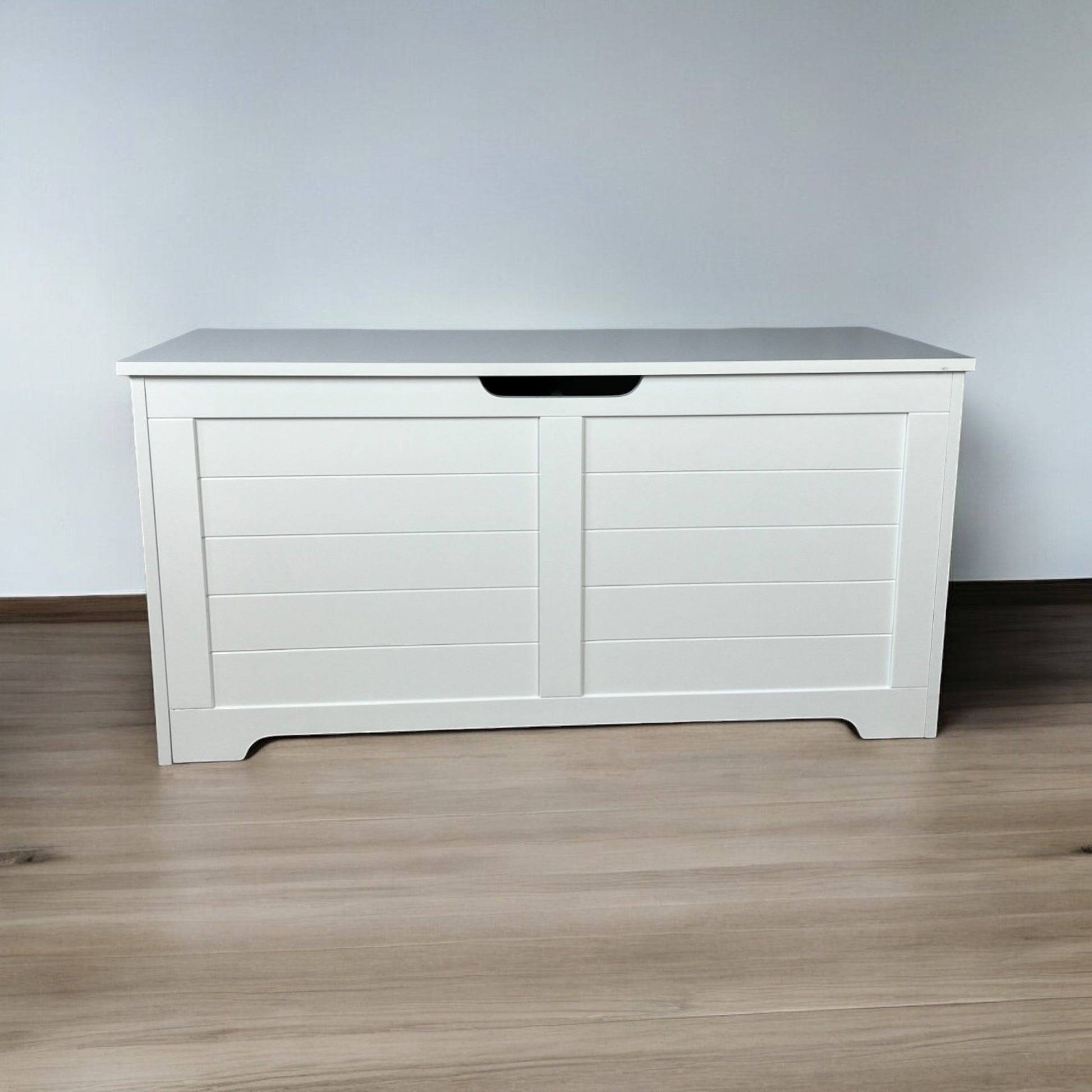 White wooden toy chest with paneled doors and integrated handle perfect for organizing childrens rooms