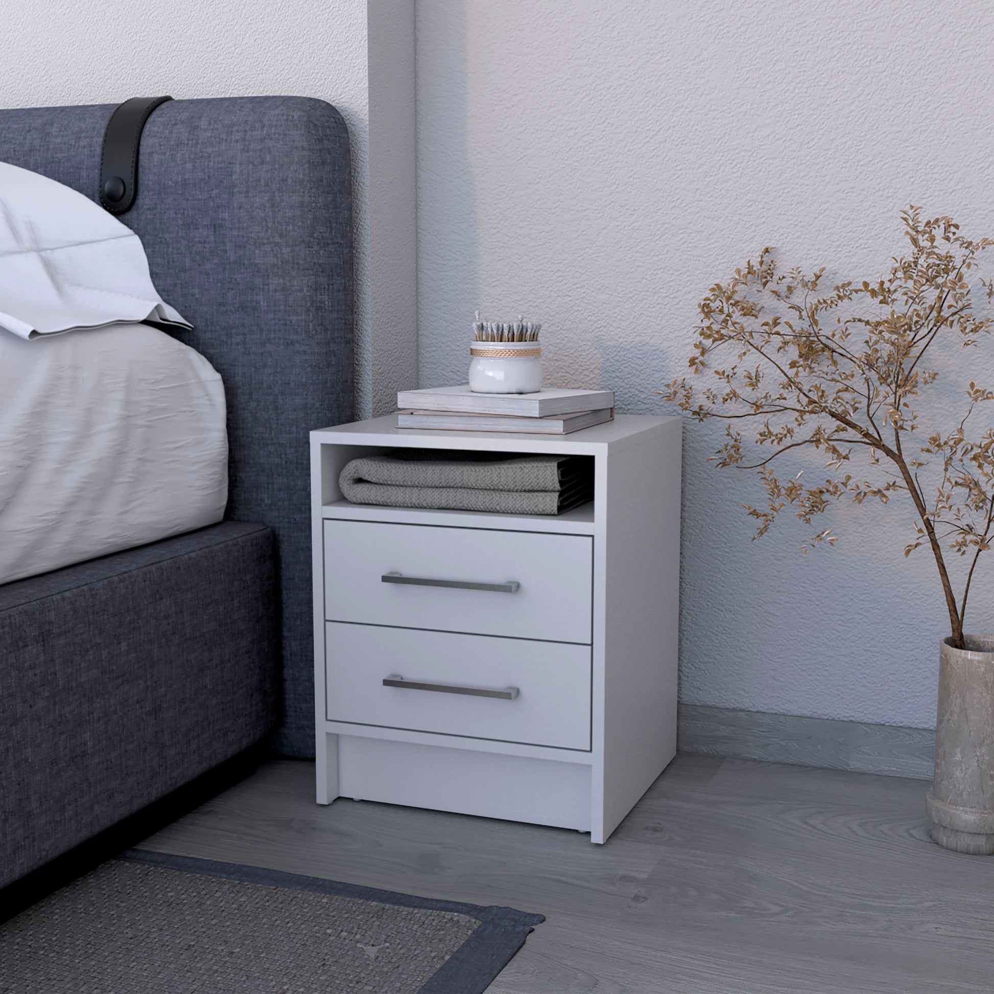 White modern nightstand with two drawers and open shelf beside bed