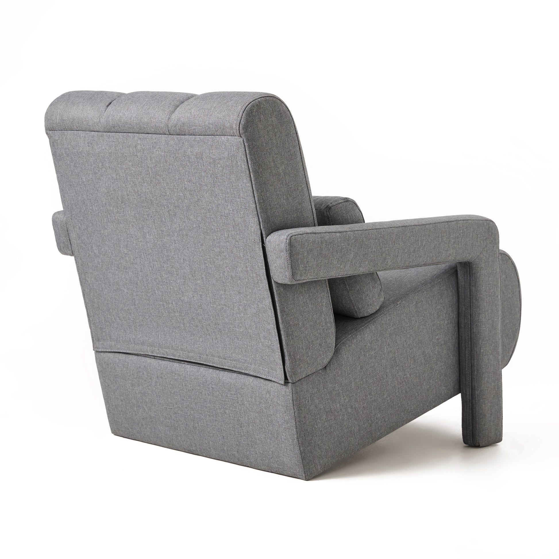 Grey fabric armchair modern design with button tufting on the backrest studio shot