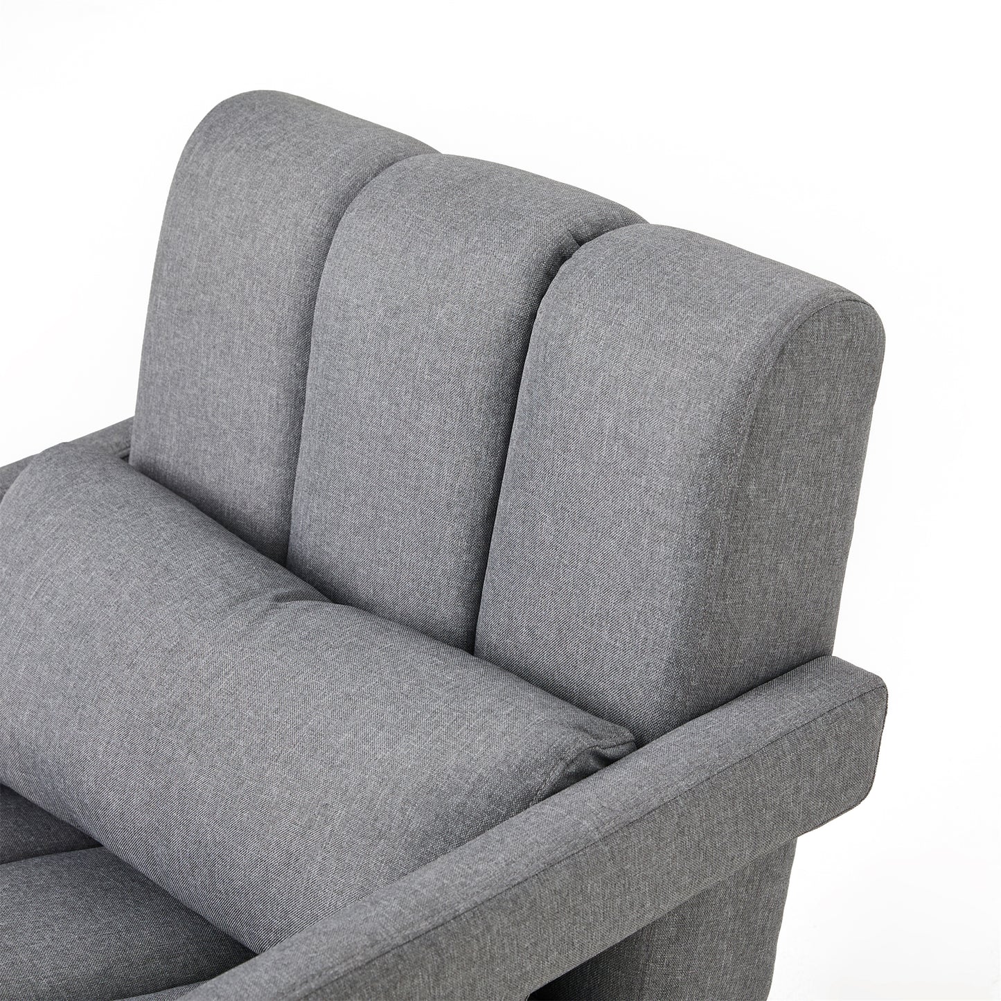 Closeup of a grey fabric armchair with tufted backrest and lumbar pillow