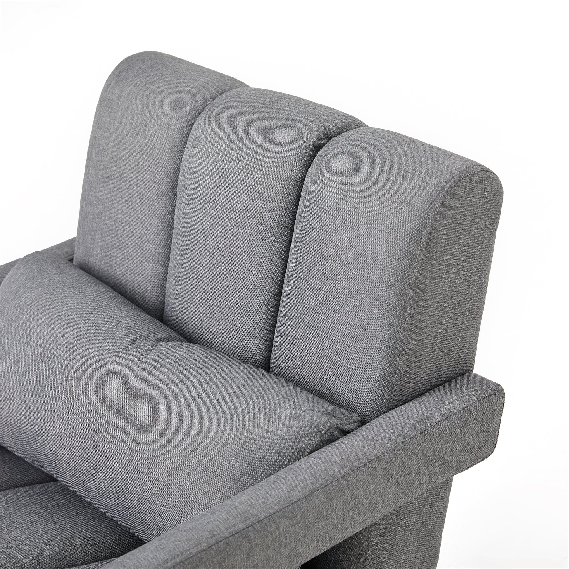 Closeup of a grey fabric armchair with tufted backrest and lumbar pillow