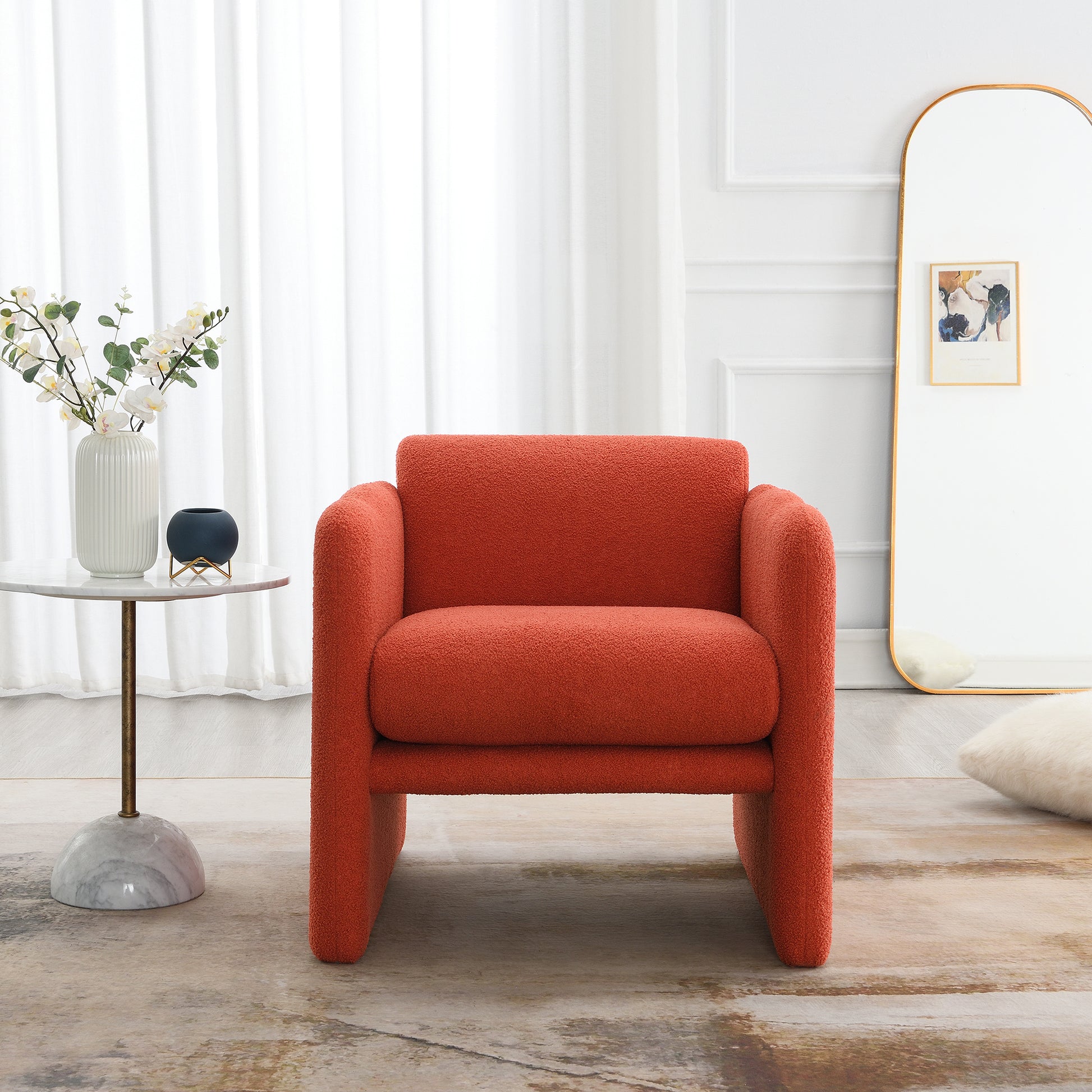 Plush teddy fabric armchair in vibrant orange with a modern sculptural design perfect for a statement living room piece