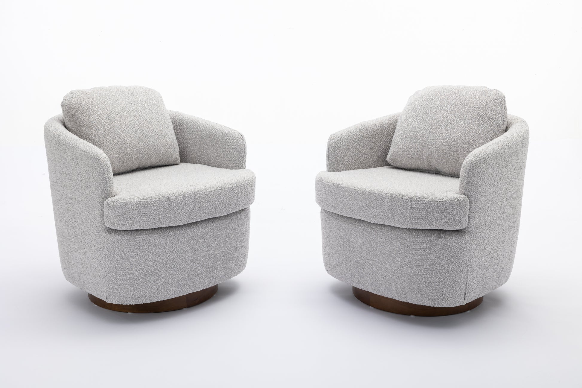 Pair of modern grey boucl swivel accent chairs with rounded bases and plush cushions