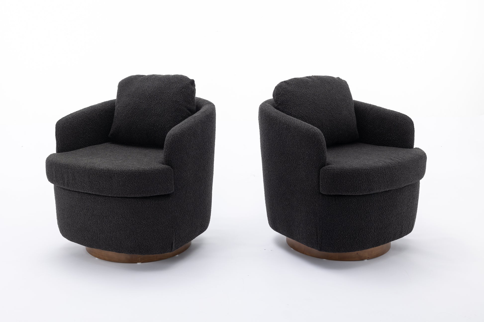 Two dark gray boucle swivel accent chairs with wooden bases
