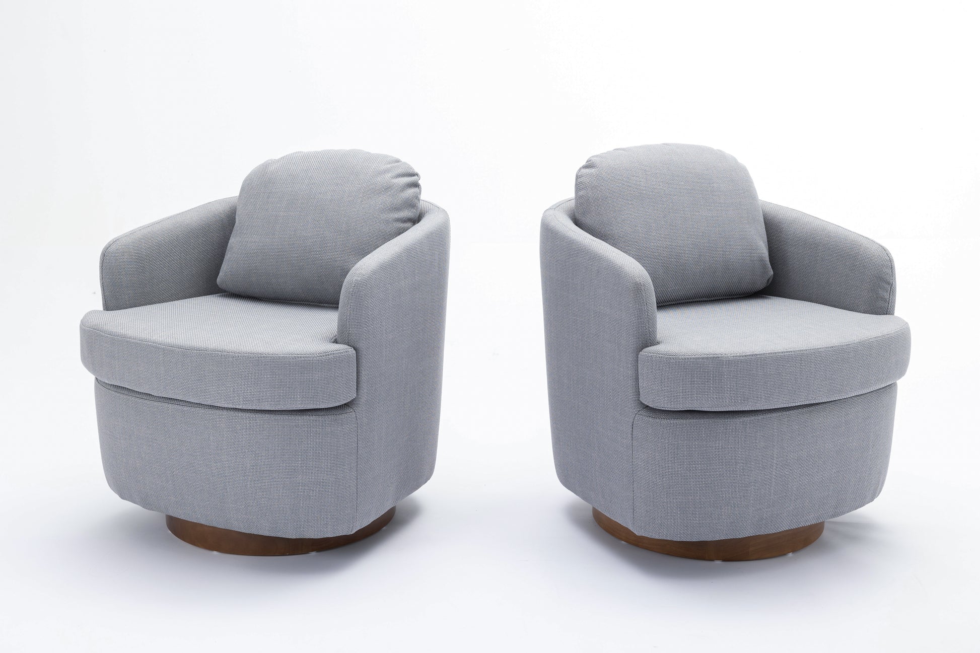 Two comfortable grey fabric swivel chairs with wooden bases perfect for a living room