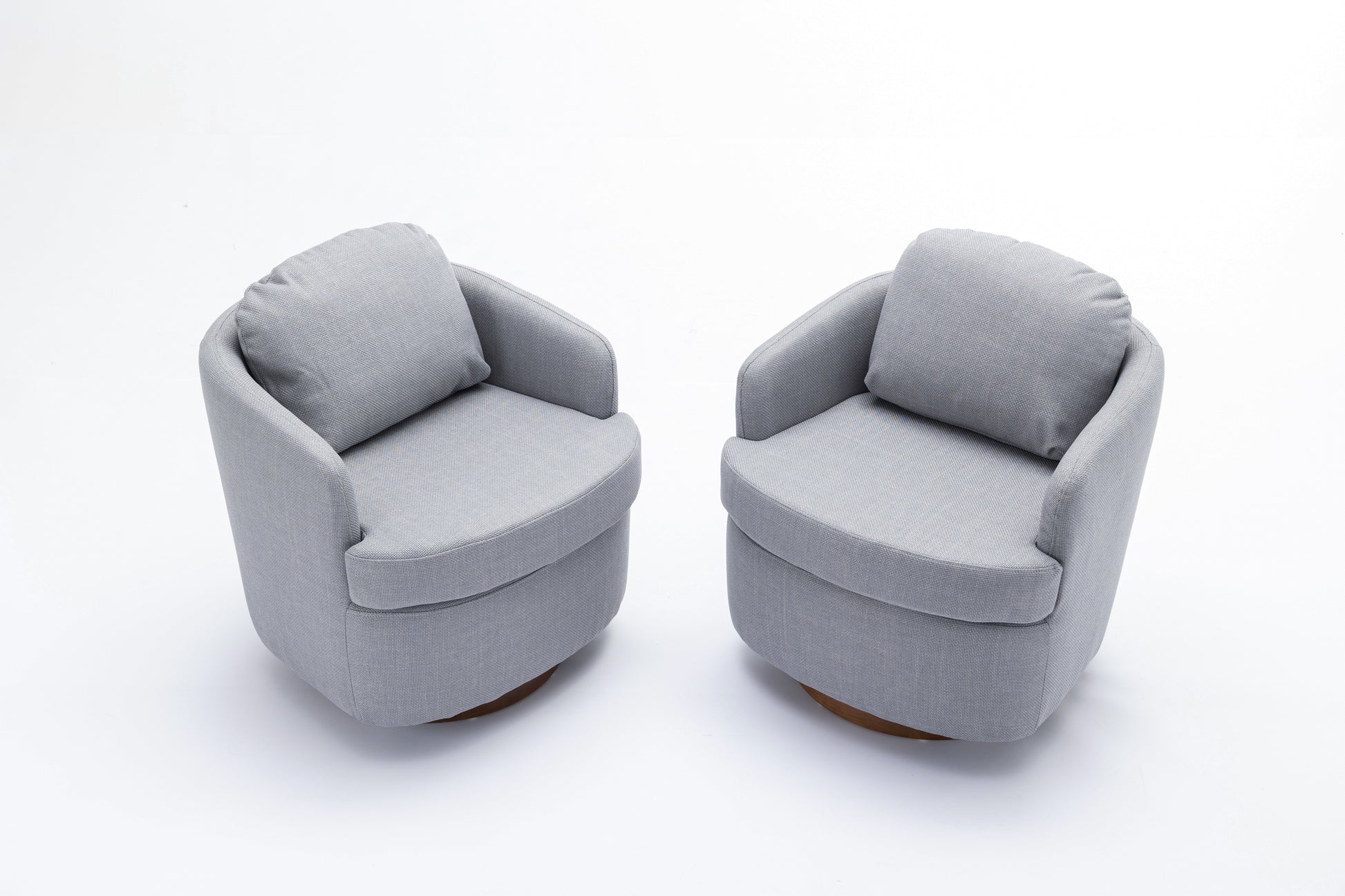 Pair of modern grey fabric accent chairs with round wooden bases