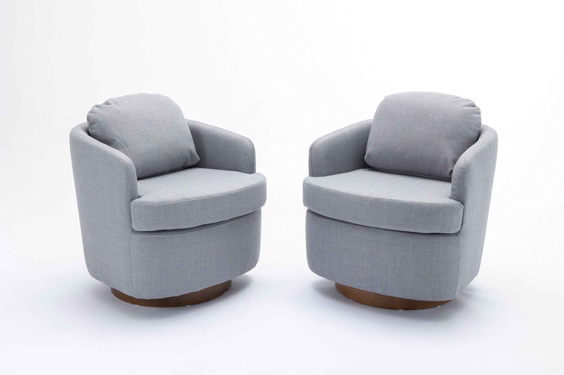Pair of grey fabric accent chairs with round wooden bases