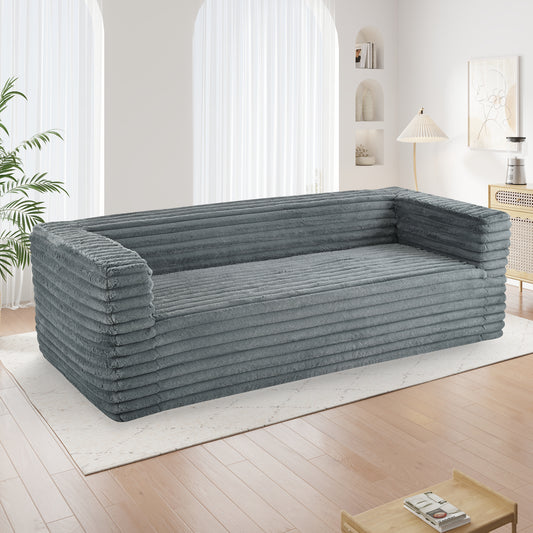 Grey corduroy sofa with plush textured upholstery for a cozy living room
