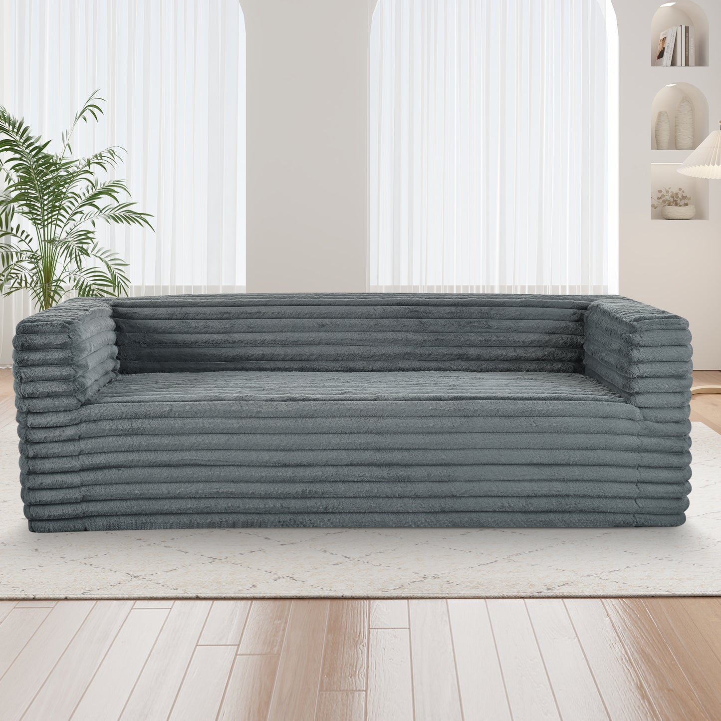 Grey corduroy sofa with plush fabric offering comfortable seating