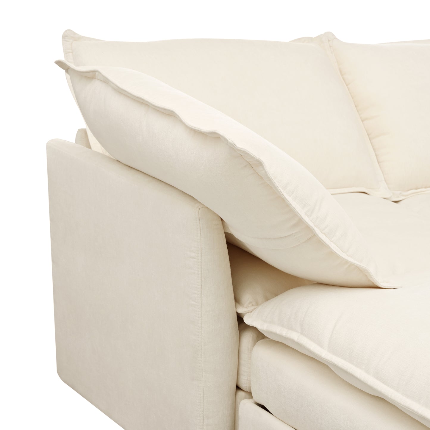 Closeup of plush ivory sectional sofa armrest and throw pillows
