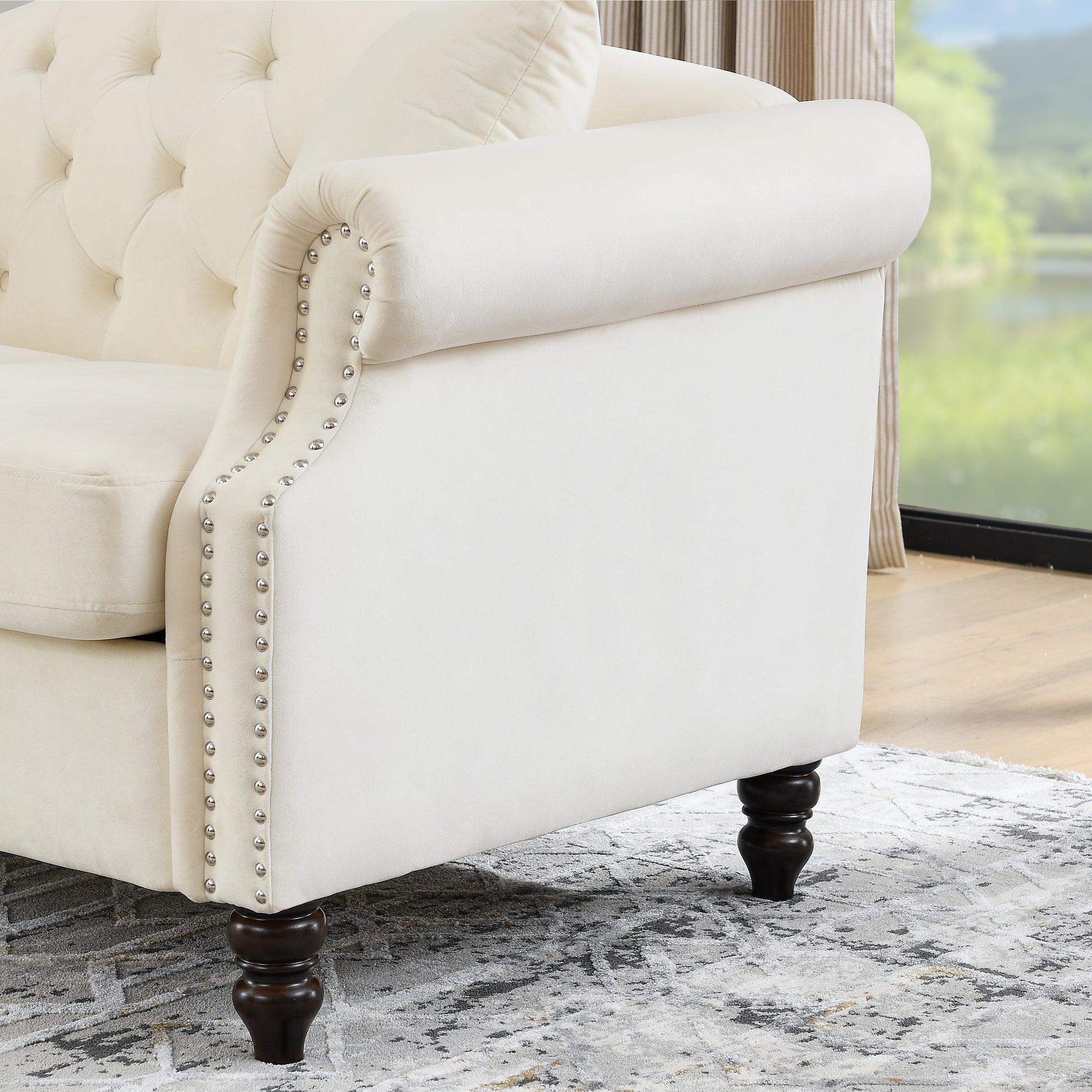 Cream velvet chesterfield sofa arm with silver nailhead trim detail