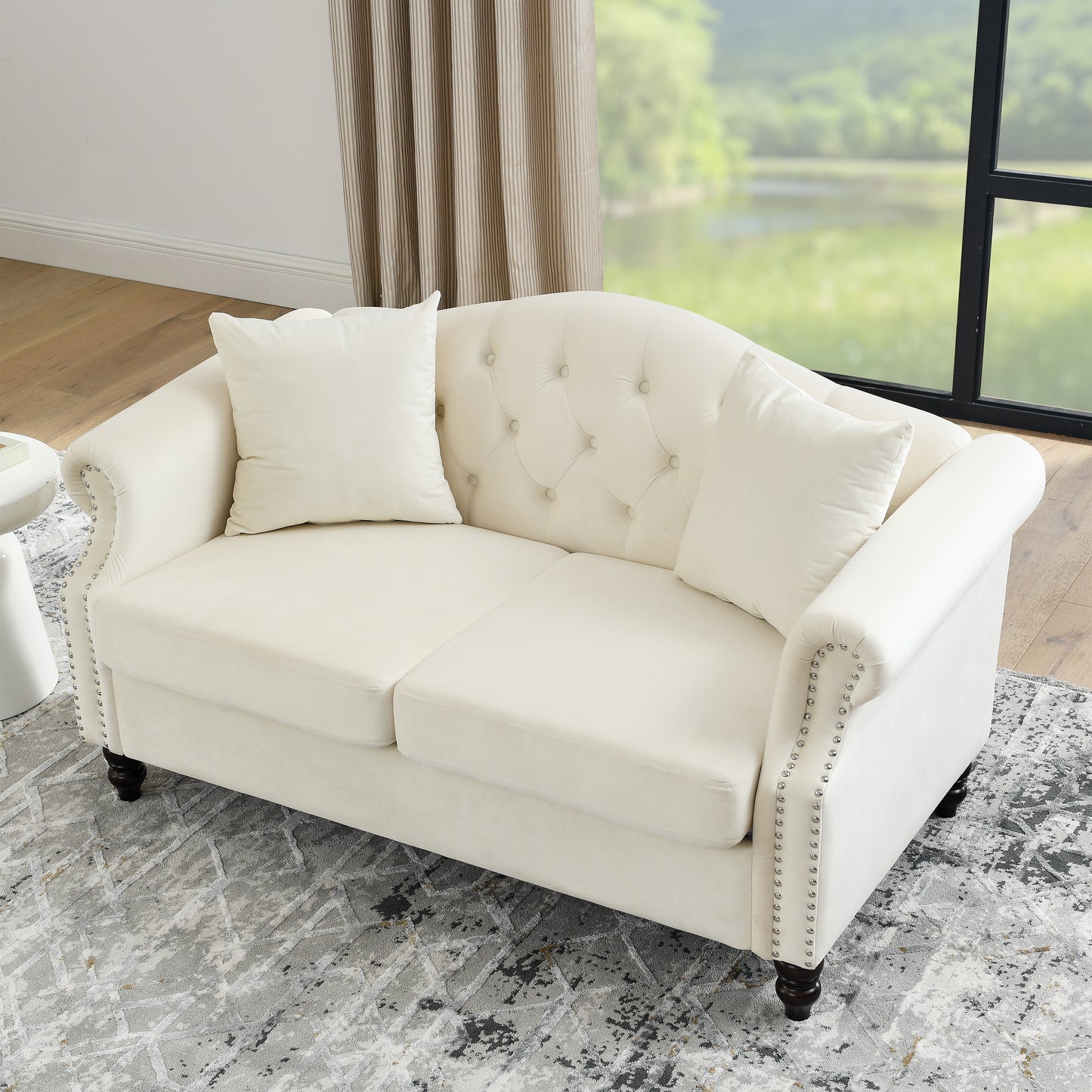 Elegant cream velvet loveseat with tufted back and nailhead trim for living room seating