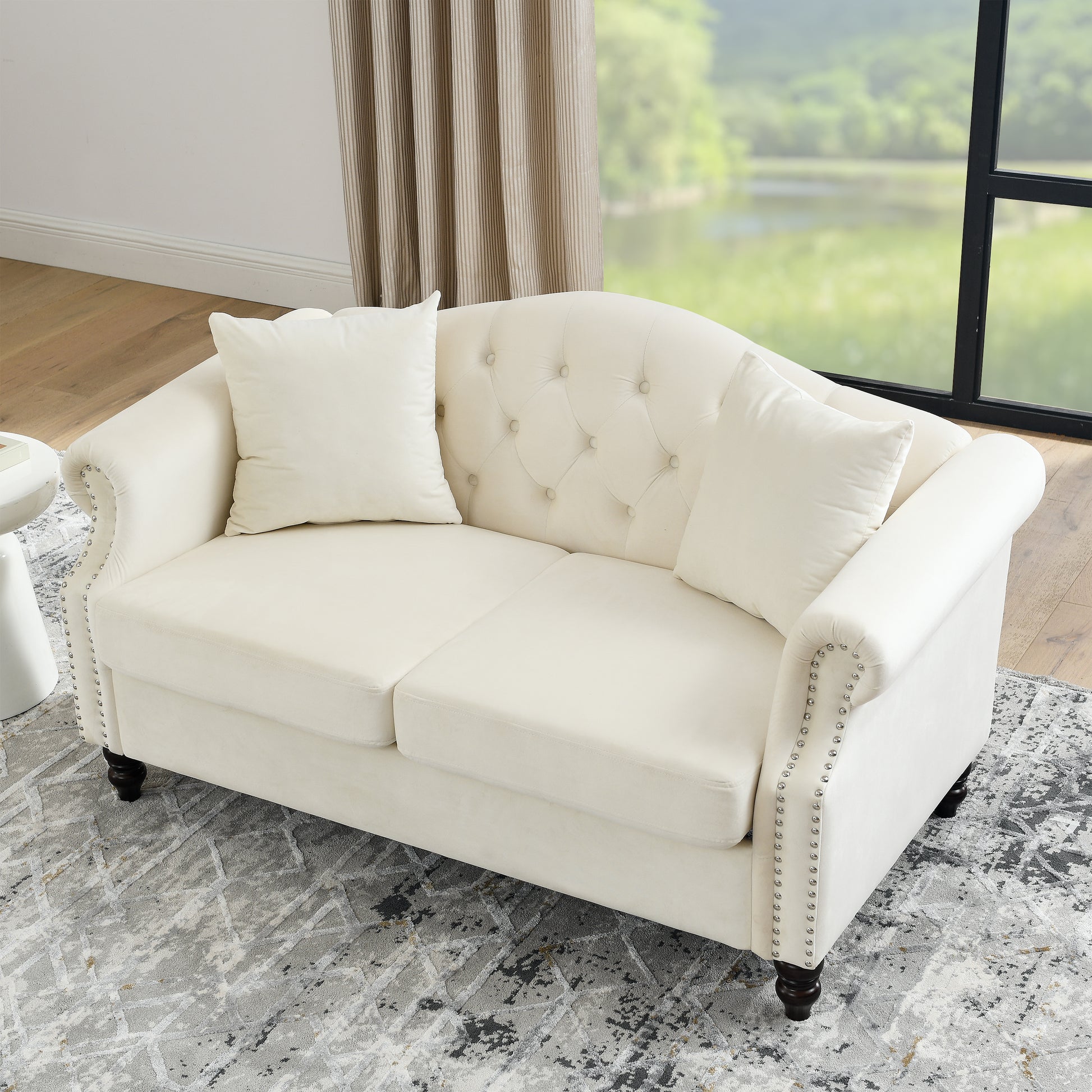 Elegant cream velvet loveseat with tufted back and nailhead trim for living room seating